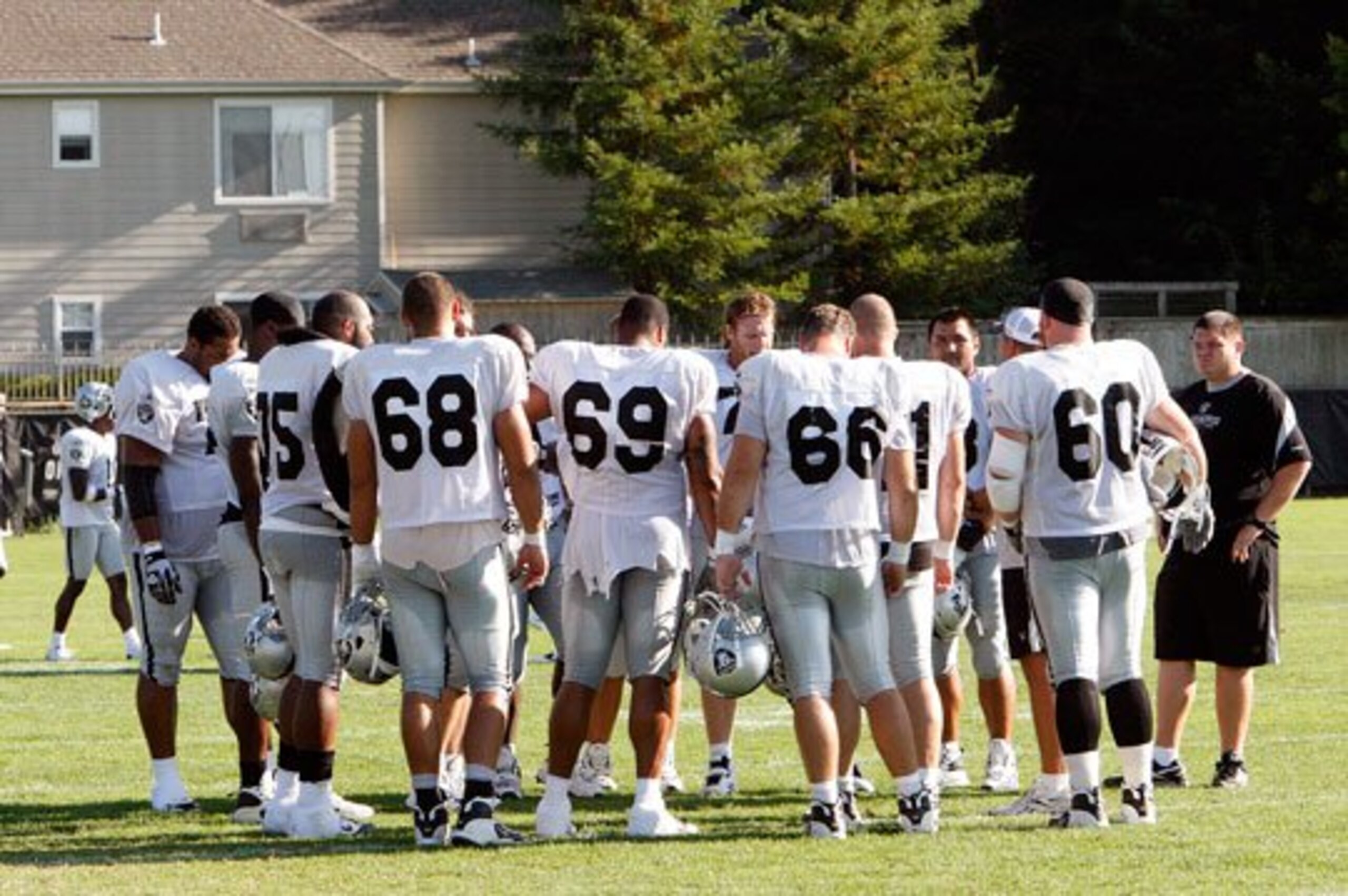 Offensive linemen get instructions for a day of practice.