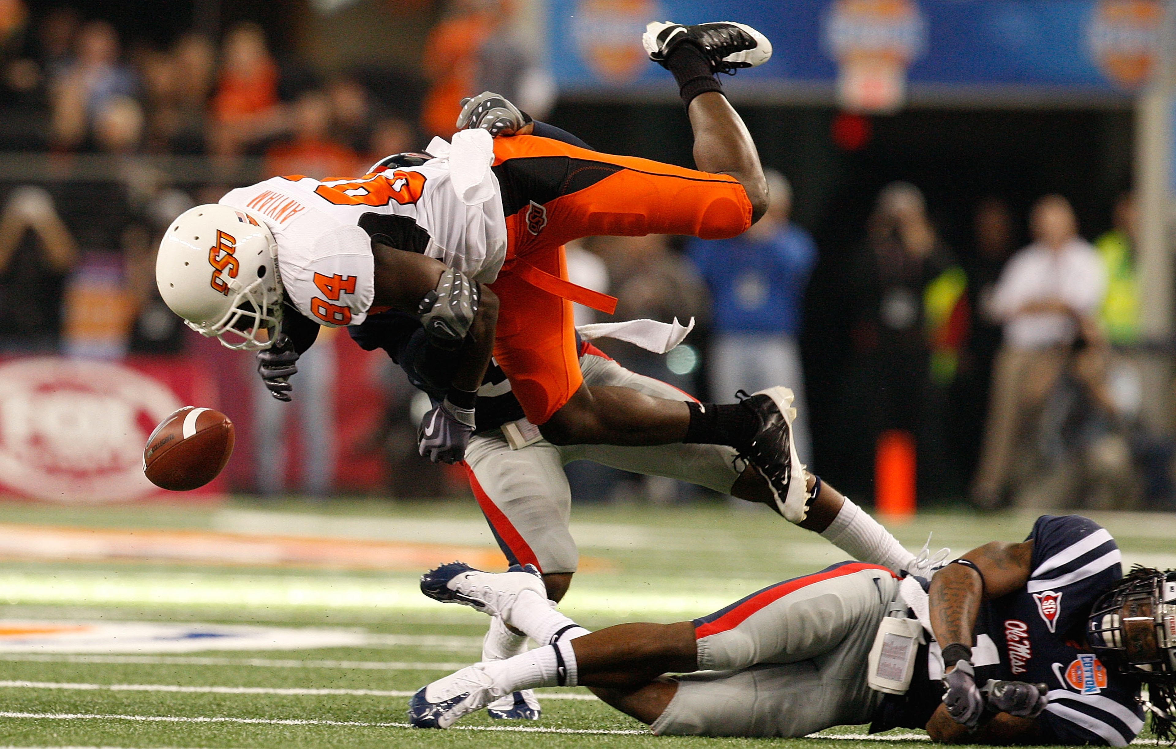 ARLINGTON, TX - JANUARY 02: Hubert Anyiam #84 of the Oklahoma State Cowboys fumbles the ball while tackled by Fon Ingram #35 of the Mississippi Rebels and the Oklahoma State Cowboys during the AT&T Cotton Bowl on January 2, 2010 at Cowboys Stadium in Arl ARLINGTON, TX - JANUARY 02: Hubert Anyiam #84 of the Oklahoma State Cowboys fumbles the ball while tackled by Fon Ingram #35 of the Mississippi Rebels and the Oklahoma State Cowboys during the AT&T Cotton Bowl on January 2, 2010 at Cowboys Stadium in Arl