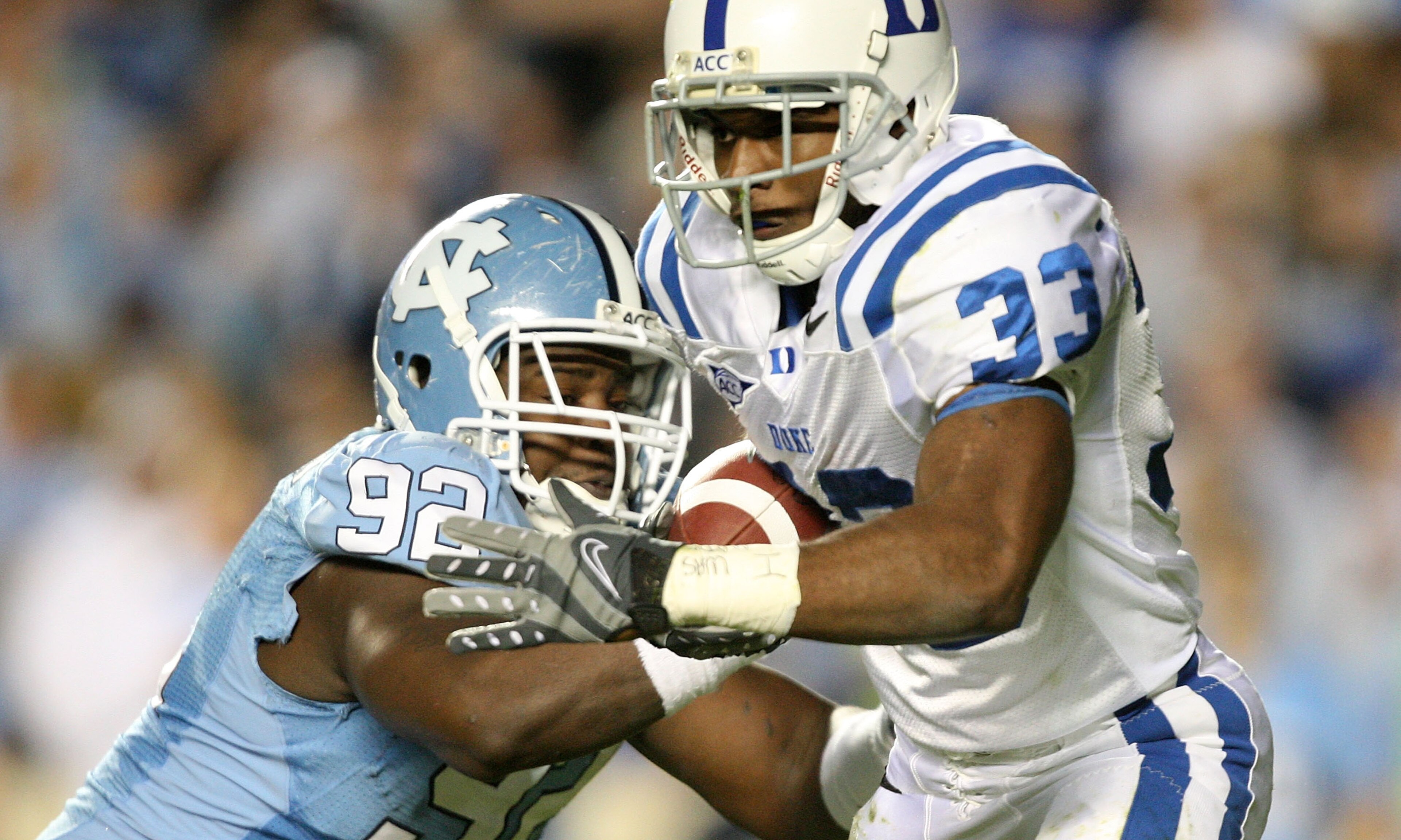 CHAPEL HILL, NC - NOVEMBER 07: Desmond Scott #33 of the Duke Blue Devils is tackled by E.J. Wilson #92 of the North Carolina Tar Heels during their game at Kenan Stadium on November 7, 2009 in Chapel Hill, North Carolina. (Photo by Streeter Lecka/Getty CHAPEL HILL, NC - NOVEMBER 07: Desmond Scott #33 of the Duke Blue Devils is tackled by E.J. Wilson #92 of the North Carolina Tar Heels during their game at Kenan Stadium on November 7, 2009 in Chapel Hill, North Carolina. (Photo by Streeter Lecka/Getty