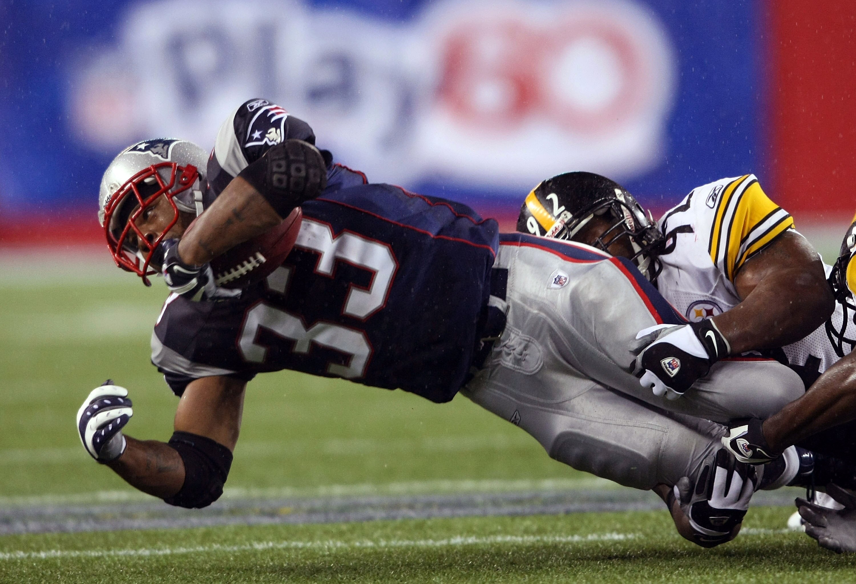 FOXBORO, MA - NOVEMBER 30:  Kevin Faulk #33 of the New England Patriots is taken down by James Harrison #92 of the Pittsburgh Steelers on November 30, 2008 at Gillette Stadium in Foxboro, Massachusetts.  (Photo by Elsa/Getty Images)