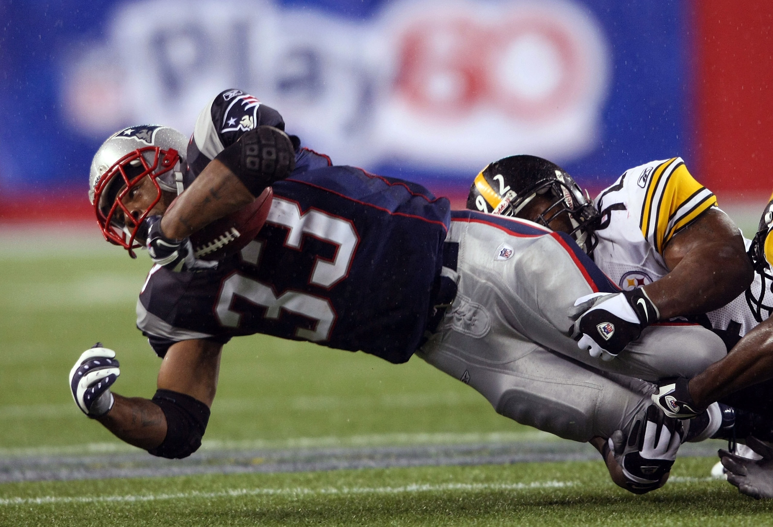 FOXBORO, MA - NOVEMBER 30:  Kevin Faulk #33 of the New England Patriots is taken down by James Harrison #92 of the Pittsburgh Steelers on November 30, 2008 at Gillette Stadium in Foxboro, Massachusetts.  (Photo by Elsa/Getty Images)