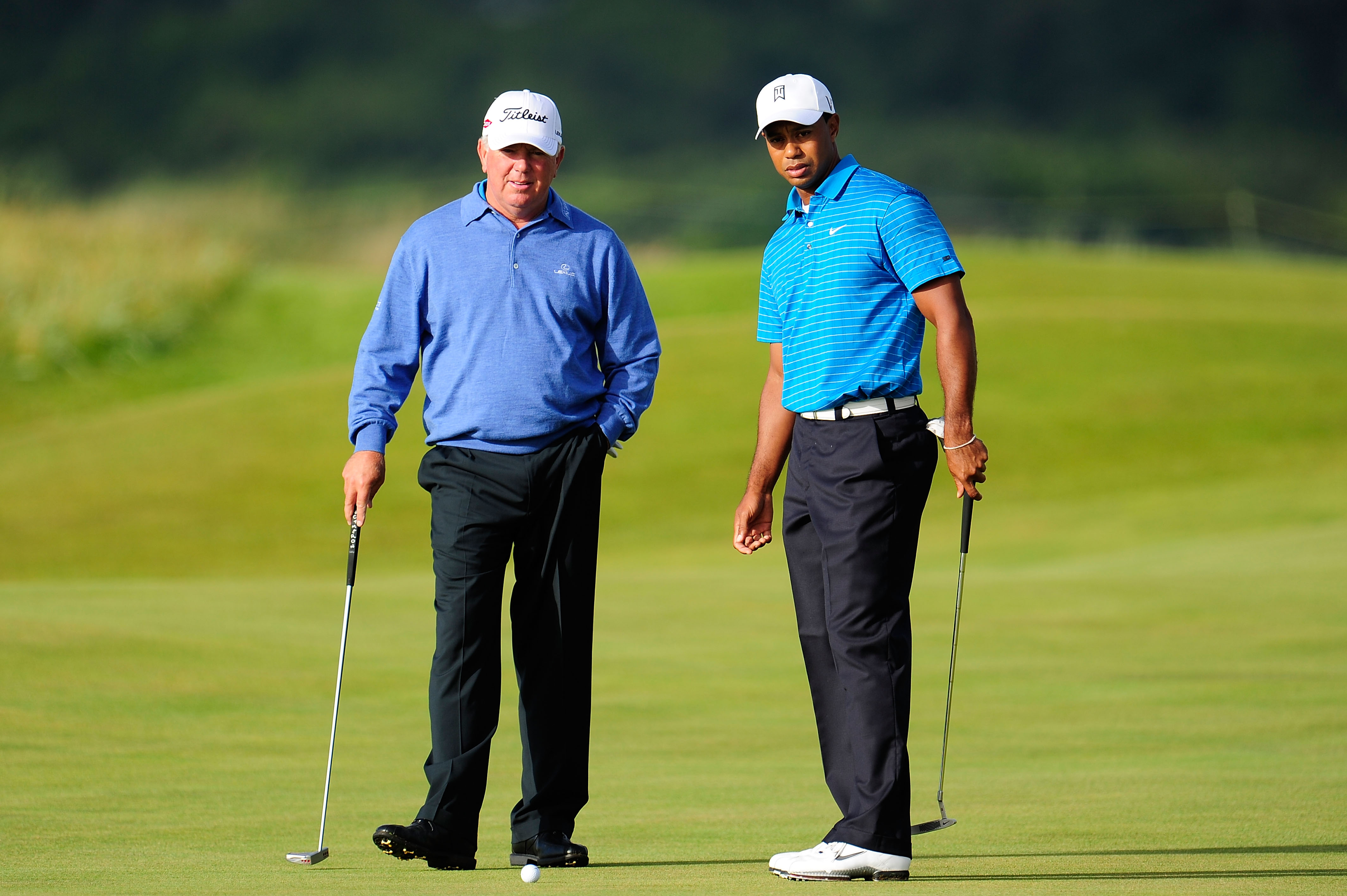 ST ANDREWS, SCOTLAND - JULY 13:  Mark O'Meara (L) and Tiger Woods of the United States practice putting during practice for the 139th Open Championship on the Old Course, St Andrews on July 13, 2010 in St Andrews, Scotland.  (Photo by Stuart Franklin/Gett