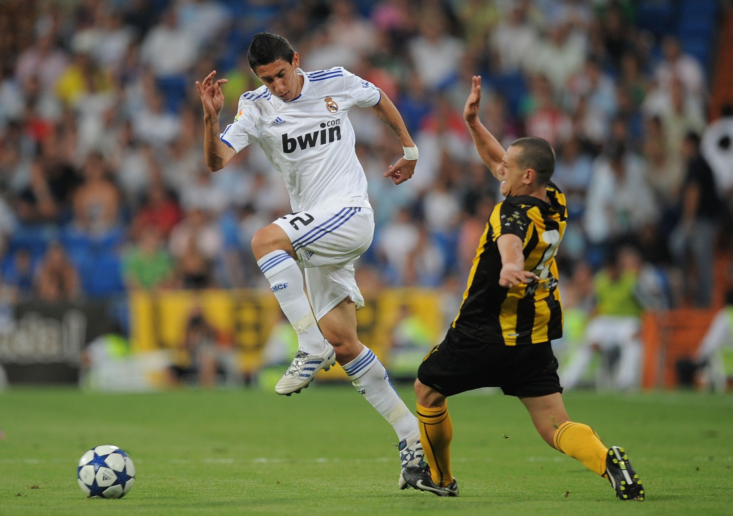 MADRID, SPAIN - AUGUST 24: Angel Di Maria (L) of Real Madrid beats a Penarol player during the Santiago Bernabeu Trophy match between Real Madrid and Penarol at the Santiago Bernabeu stadium on August 24, 2010 in Madrid, Spain.  (Photo by Denis Doyle/Gett