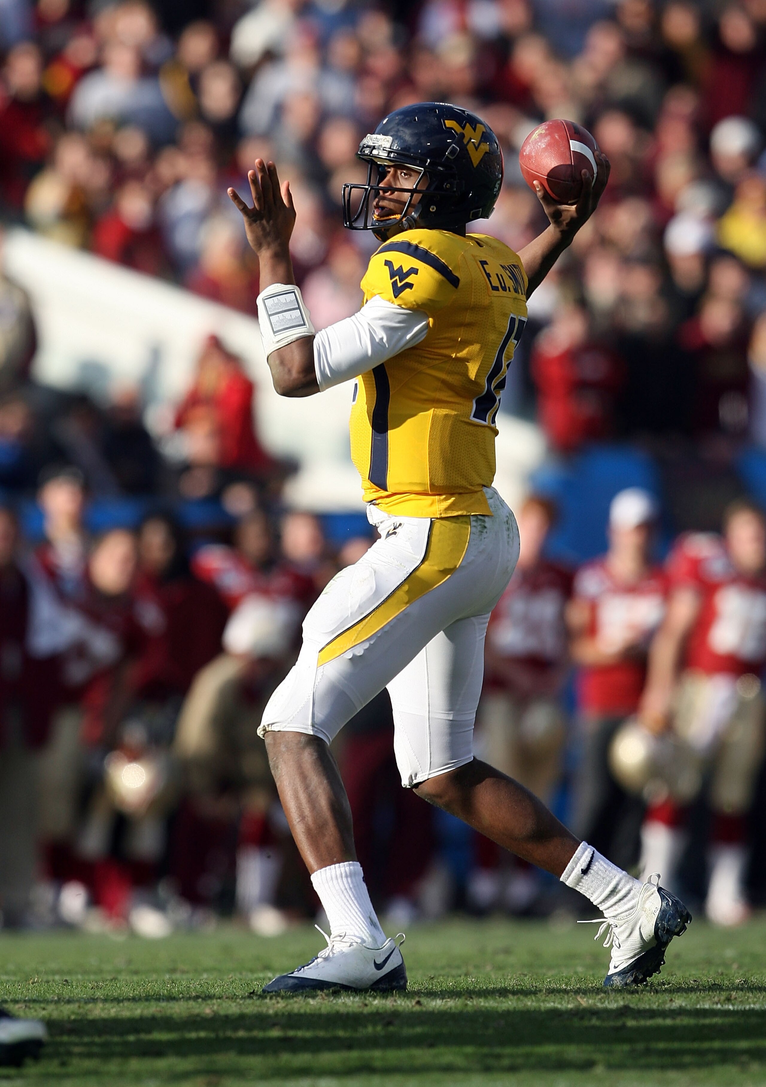 JACKSONVILLE, FL - JANUARY 01: Quarterback Geno Smith #12 of the West Virginia Mountaineers throws a pass against the Florida State Seminoles during the Konica Minolta Gator Bowl on January 1, 2010 at Jacksonville Municipal Stadium in Jacksonville, Florid