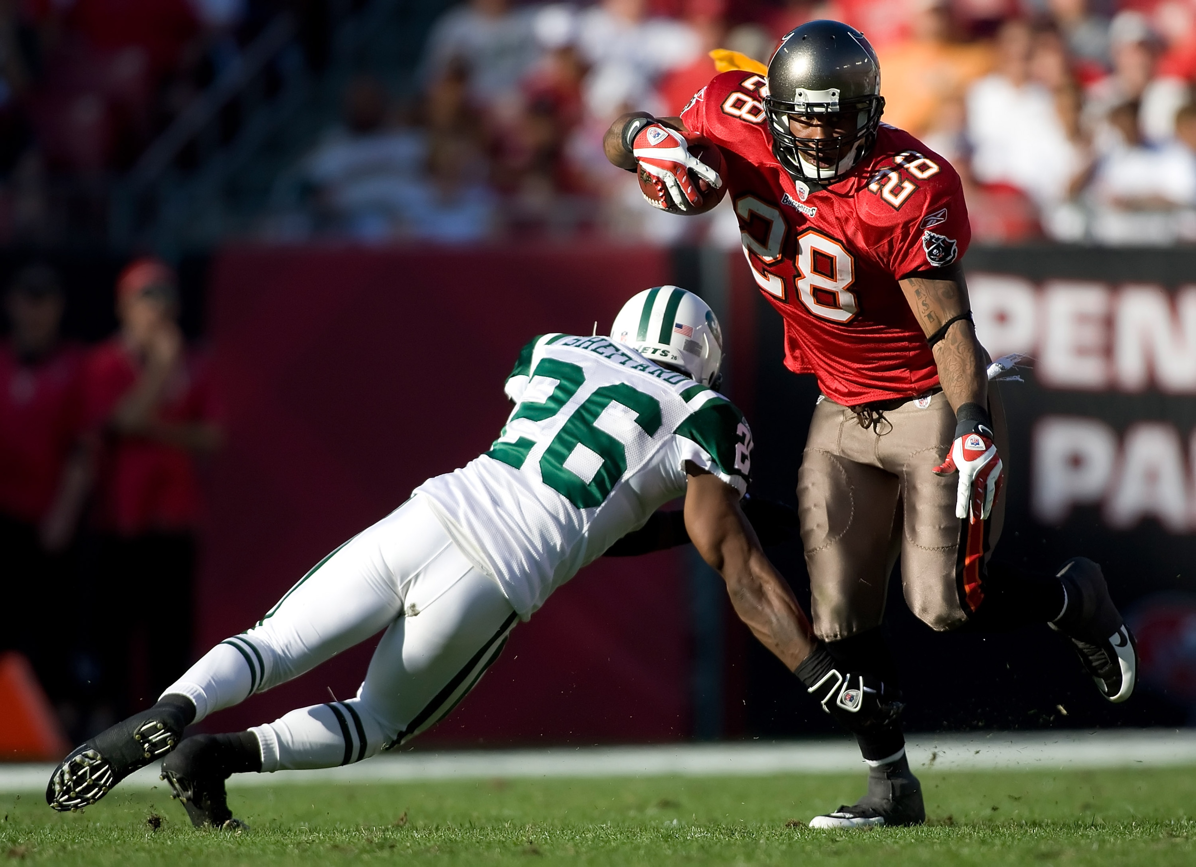 TAMPA, FL - DECEMBER 13:  Running back Derrick Ward #28 of the Tampa Bay Buccaneers runs through the arm tackle of defensive back Lito Sheppard #26 of the New York Jets during the game at Raymond James Stadium on December 13, 2009 in Tampa, Florida.  (Pho