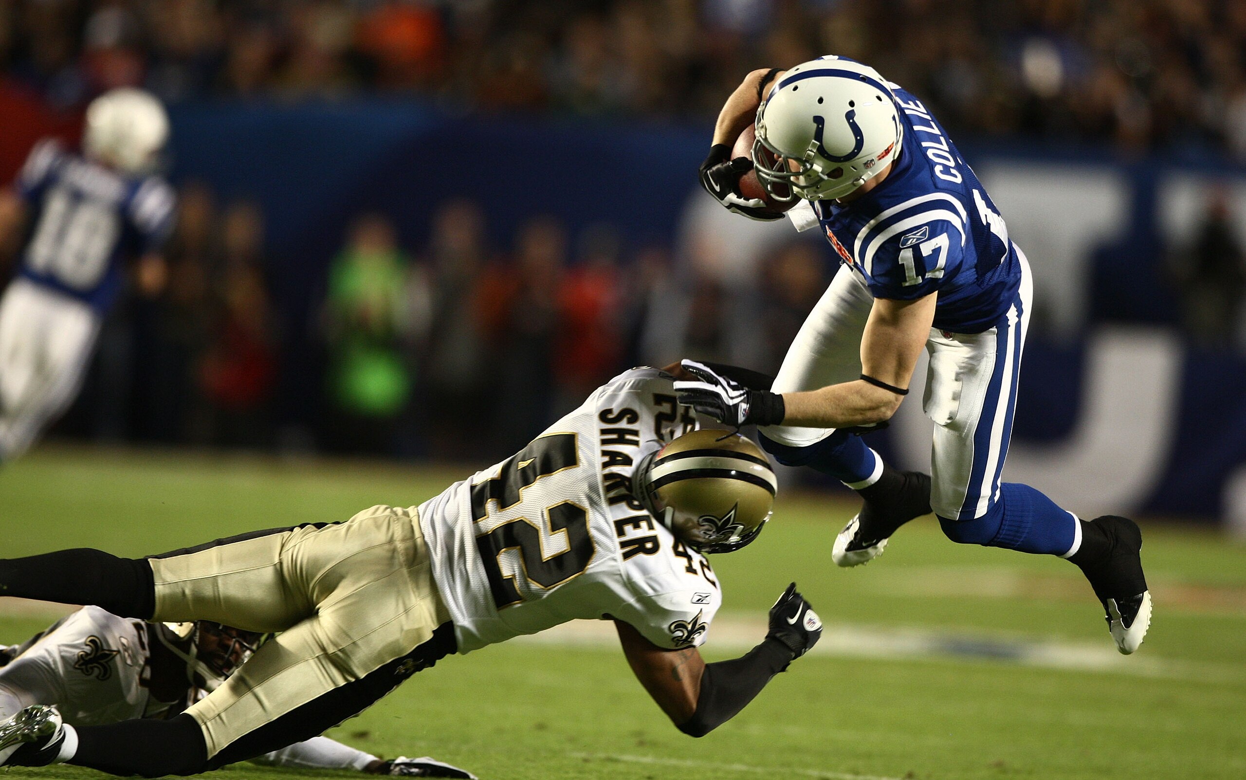 MIAMI GARDENS, FL - FEBRUARY 07: Austin Collie #17 of the Indianapolis Colts is hit by Darren Sharper #42 of the New Orleans Saints during Super Bowl XLIV on February 7, 2010 at Sun Life Stadium in Miami Gardens, Florida.  (Photo by Donald Miralle/Getty I