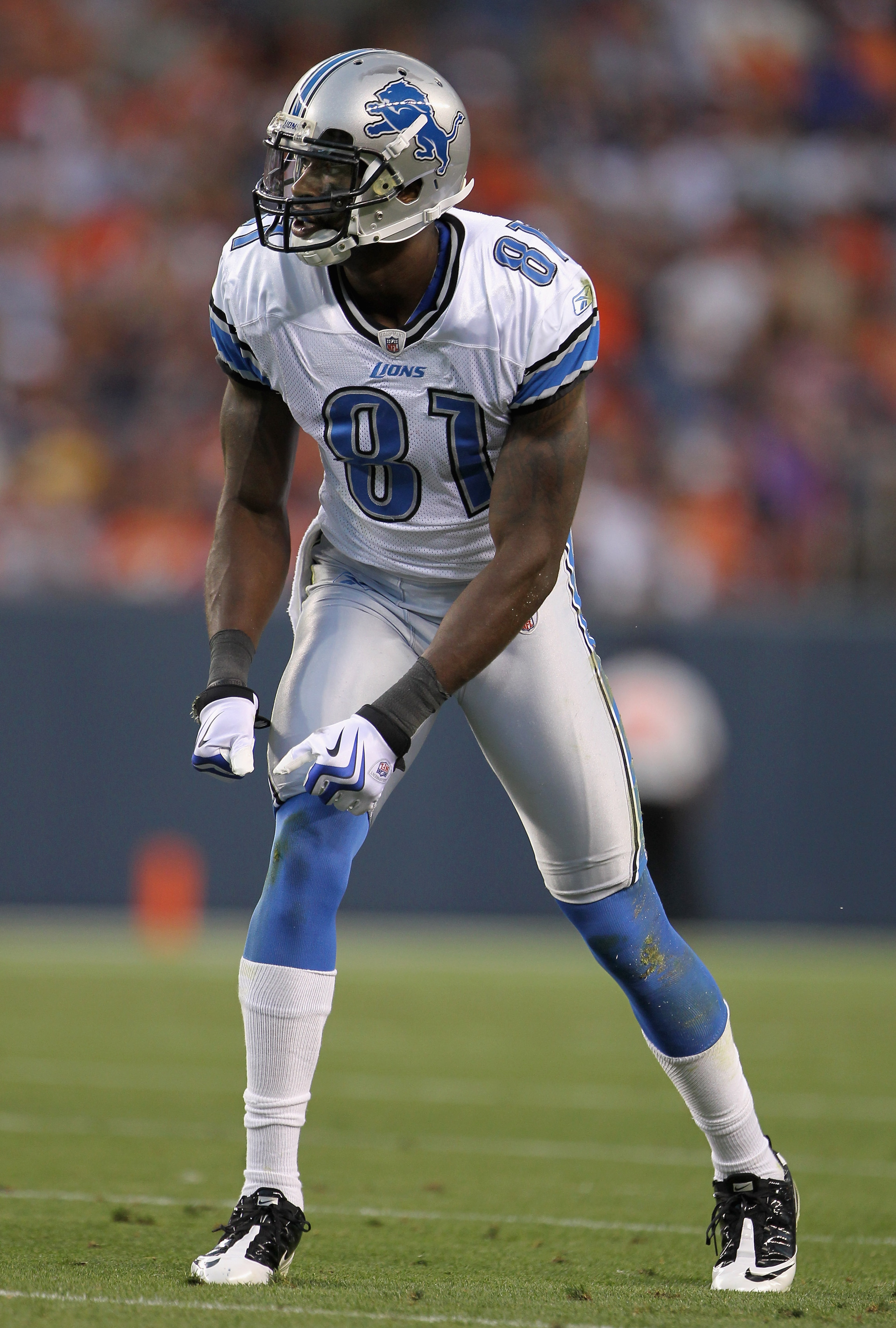 DENVER - AUGUST 21:  Wide receiver Calvin Johnson #81 of the Detroit Lions awaits the snap on the line of scrimmage against the Denver Broncos during preseason NFL action at INVESCO Field at Mile High on August 21, 2010 in Denver, Colorado. The Lions defe