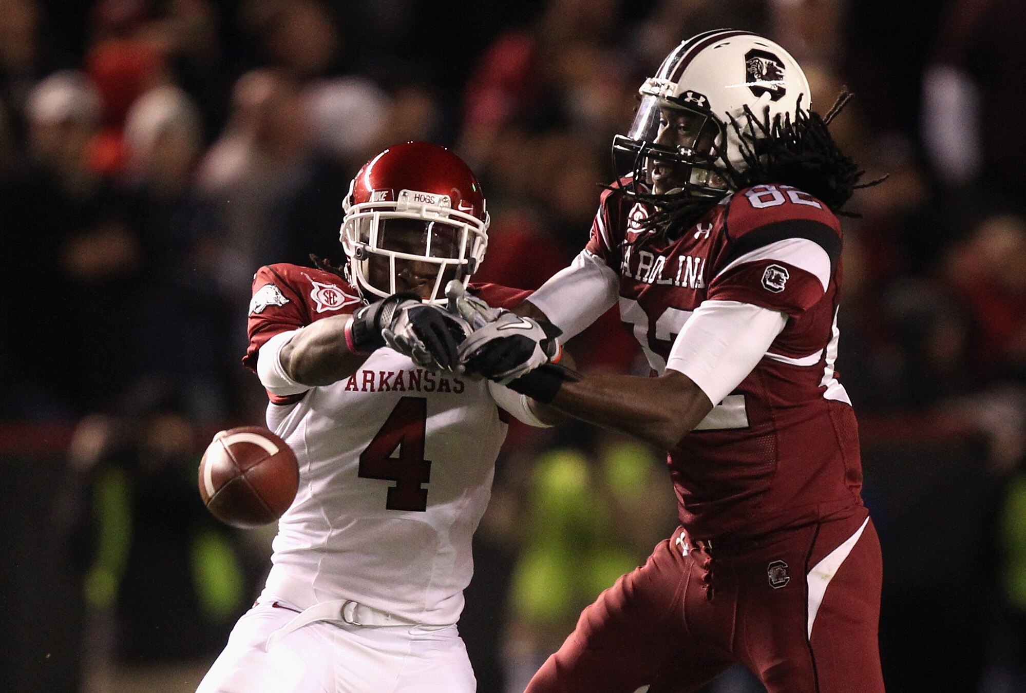 COLUMBIA, SC - NOVEMBER 06:  Rudell Crim #4 of the Arkansas Razorbacks breaks up a pass to D.L. Moore #82 of the South Carolina Gamecocks during their game at Williams-Brice Stadium on November 6, 2010 in Columbia, South Carolina.  (Photo by Streeter Leck