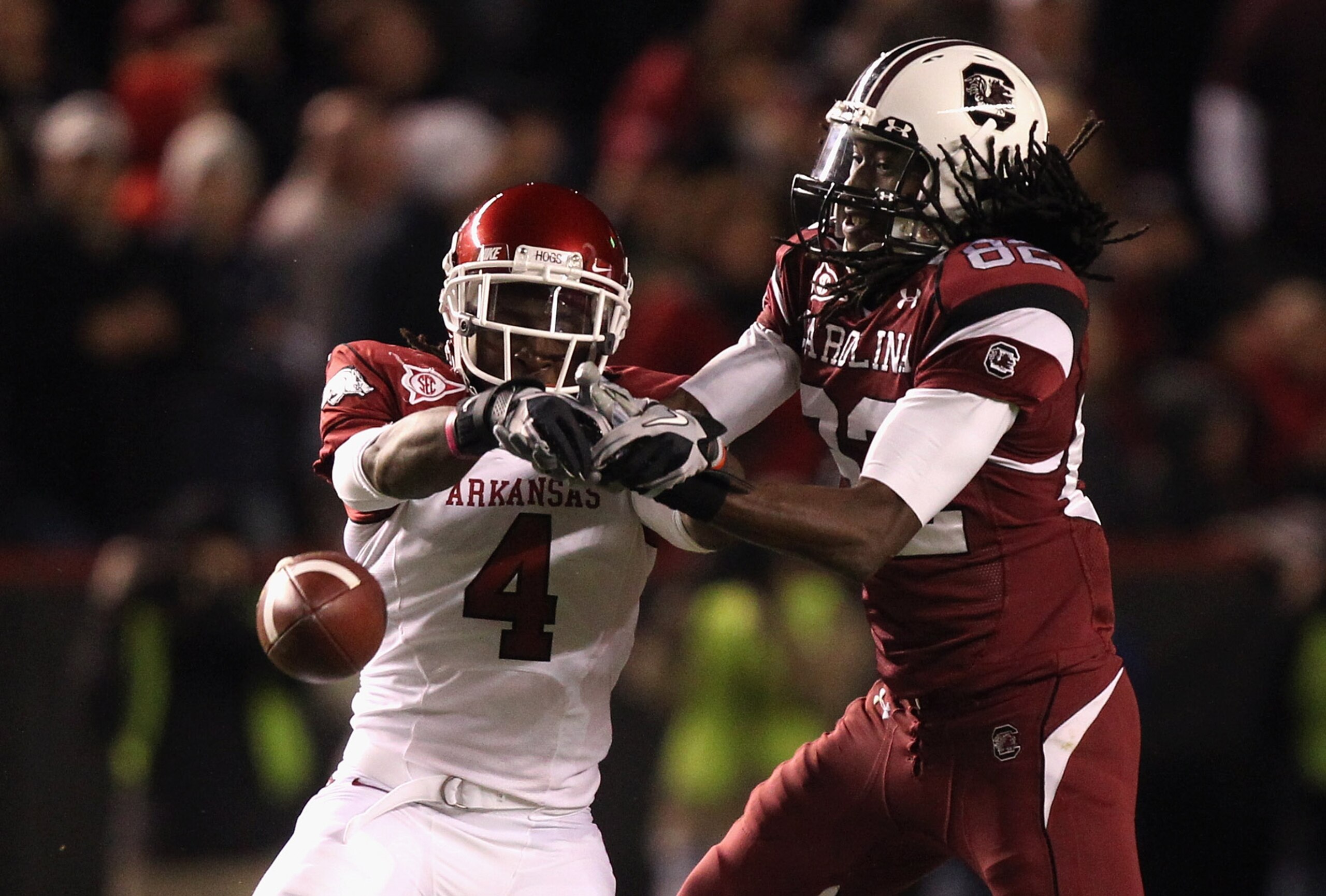 COLUMBIA, SC - NOVEMBER 06:  Rudell Crim #4 of the Arkansas Razorbacks breaks up a pass to D.L. Moore #82 of the South Carolina Gamecocks during their game at Williams-Brice Stadium on November 6, 2010 in Columbia, South Carolina.  (Photo by Streeter Leck