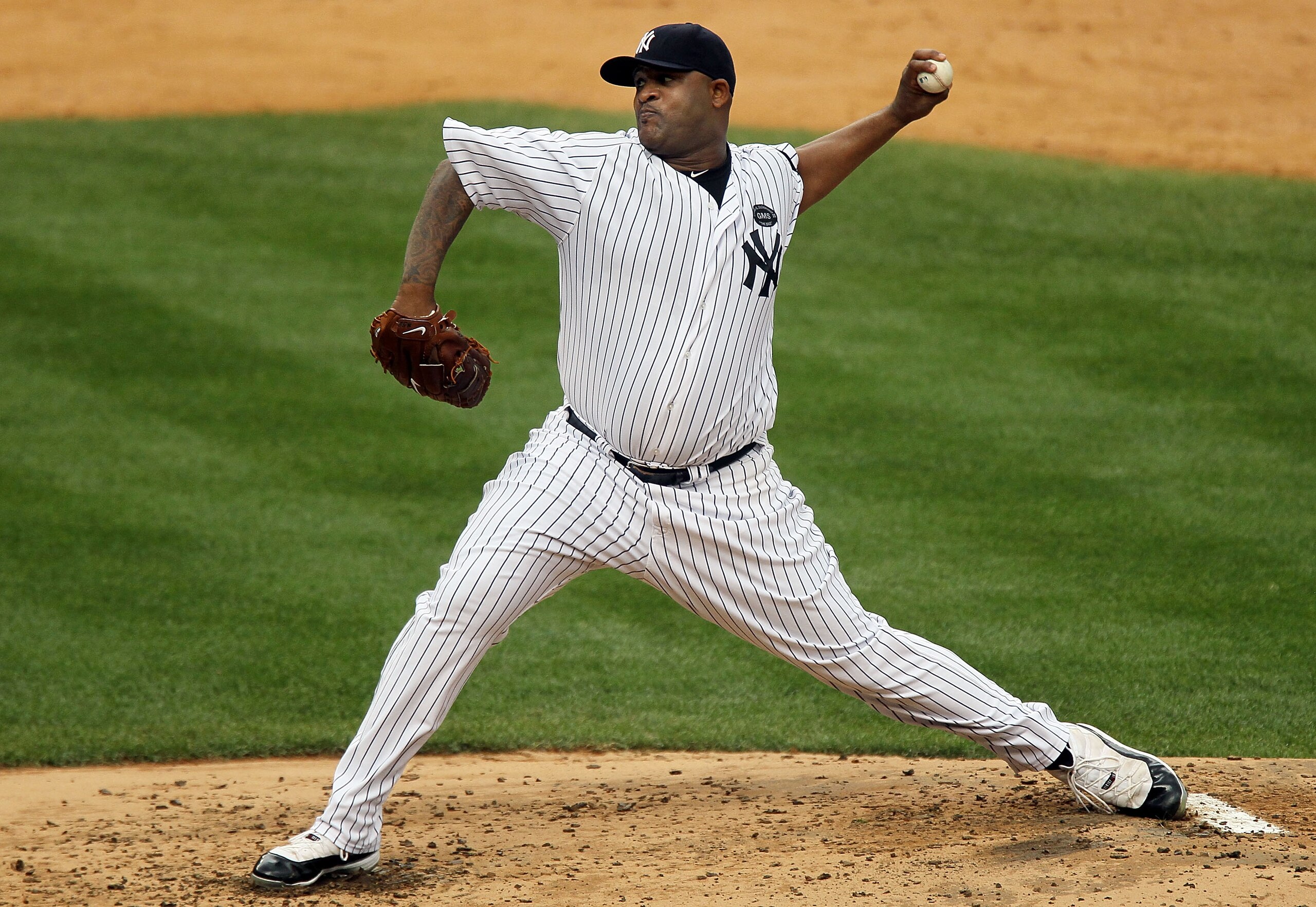 NEW YORK - AUGUST 22:  CC Sabathia #52 of the New York Yankees delivers a pitch against the Seattle Mariners on August 22, 2010 at Yankee Stadium in the Bronx borough of New York City.  (Photo by Jim McIsaac/Getty Images)