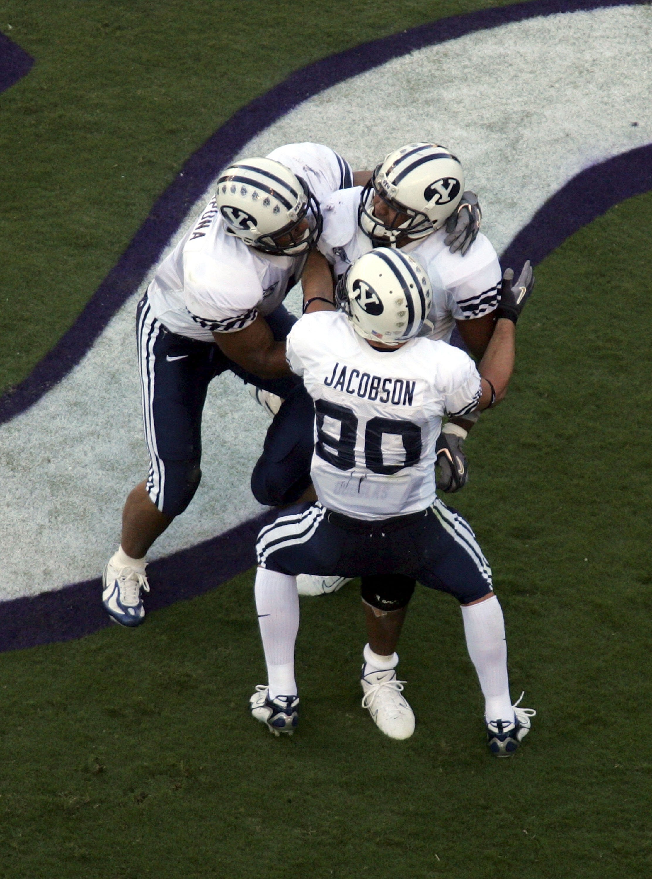 FORT WORTH, TX - SEPTEMBER 28:  Running back Manase Tonga #11 of the Brigham Young University Cougars celebrates a touchdown with Fui Vakapuna #1 and McKay Jacobson #80 during play against the Texas Christian University Horned Frogs at Amon G. Carter Stad