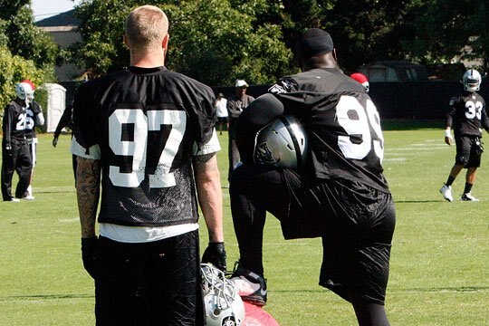 Lamarr Houston and Greyson Gunheim observe practice.