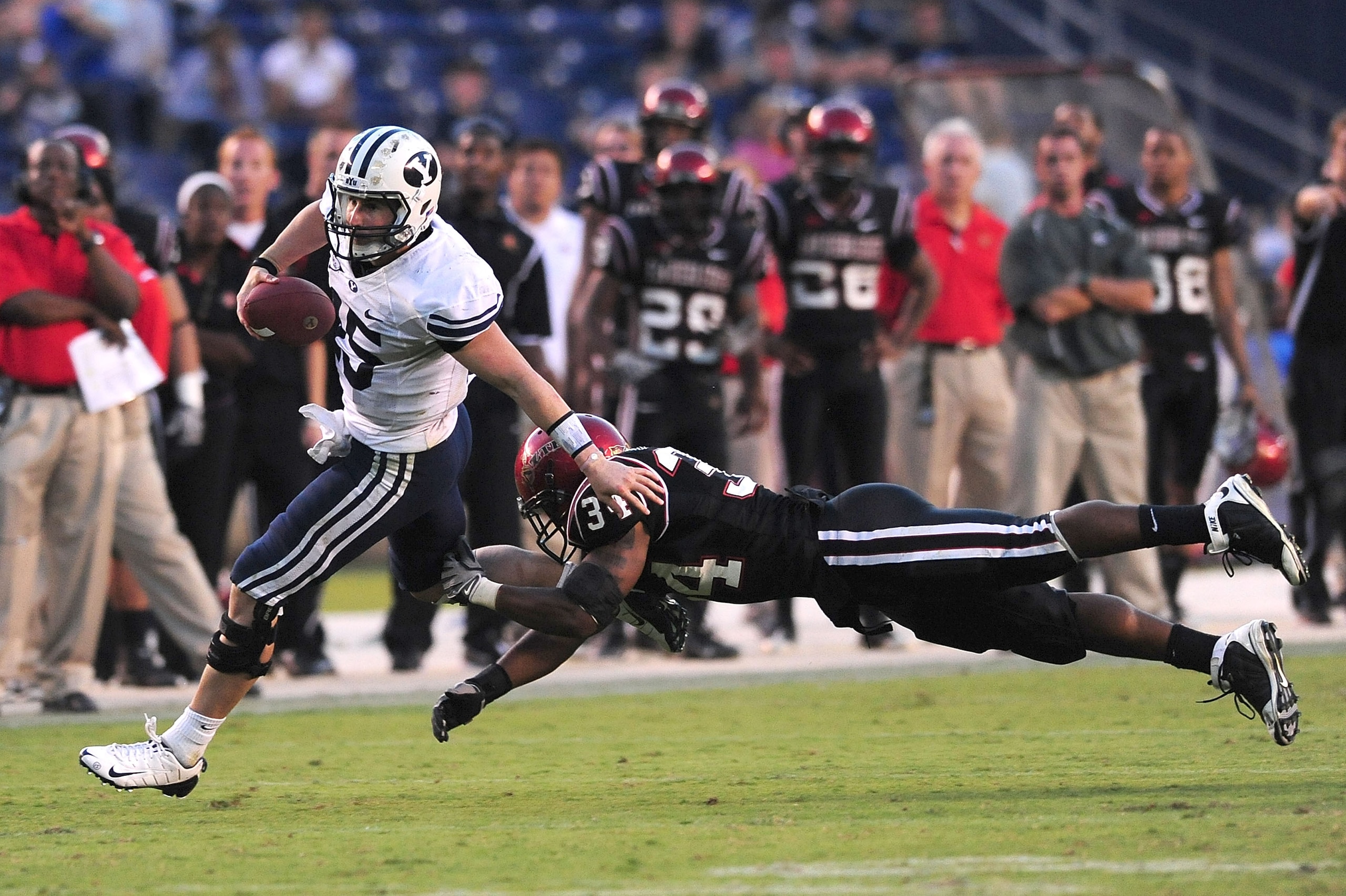 SAN DIEGO - OCTOBER 17: Max Hall #15 of BYU Cougars runs the ball and avoids getting tackeled by Jerry Milling #34 of San Diego State Aztecs at Qualcomm Stadium on October 17, 2009 in San Diego, California. BYU Cougars defeated the Aztecs 38-28  (Photo by