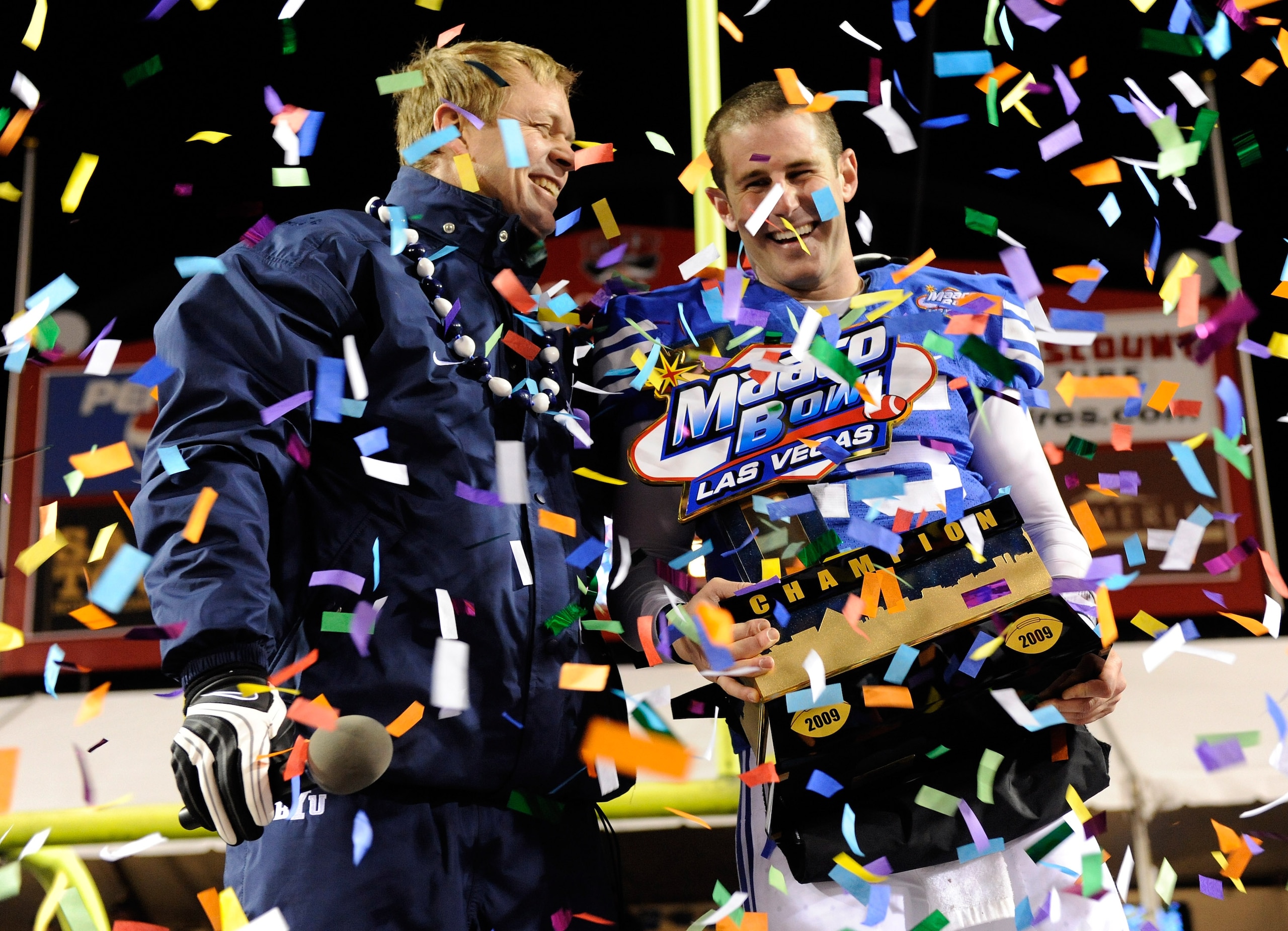 LAS VEGAS - DECEMBER 22:  Head coach Bronco Mendenhall and quarterback Max Hall #15 of the Brigham Young University Cougars celebrate their 44-20 victory over the Oregon State Beavers in the MAACO Las Vegas Bowl at Sam Boyd Stadium December 22, 2009 in La