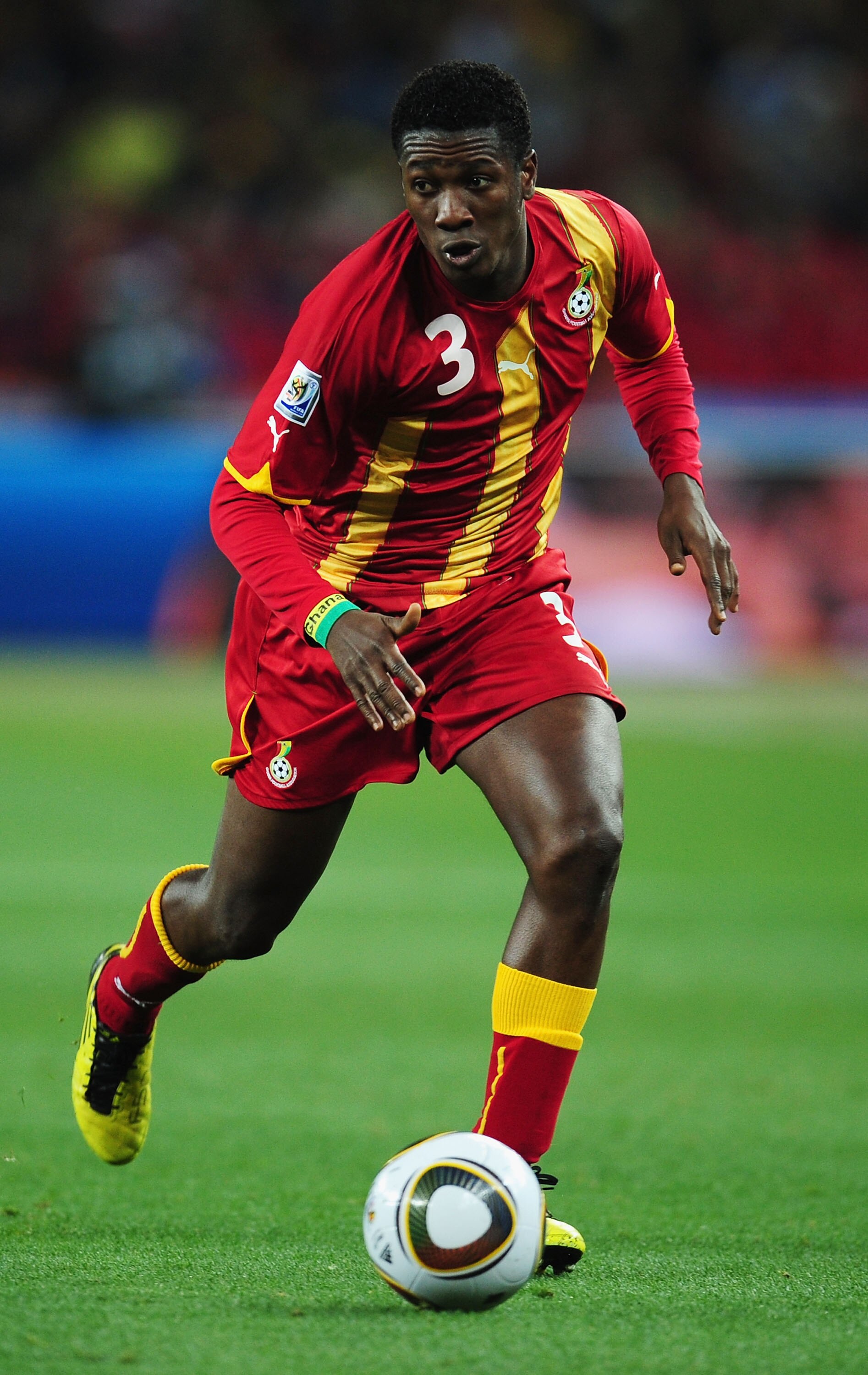 JOHANNESBURG, SOUTH AFRICA - JULY 02:  Asamoah Gyan of Ghana runs with the ball during the 2010 FIFA World Cup South Africa Quarter Final match between Uruguay and Ghana at the Soccer City stadium on July 2, 2010 in Johannesburg, South Africa.  (Photo by 