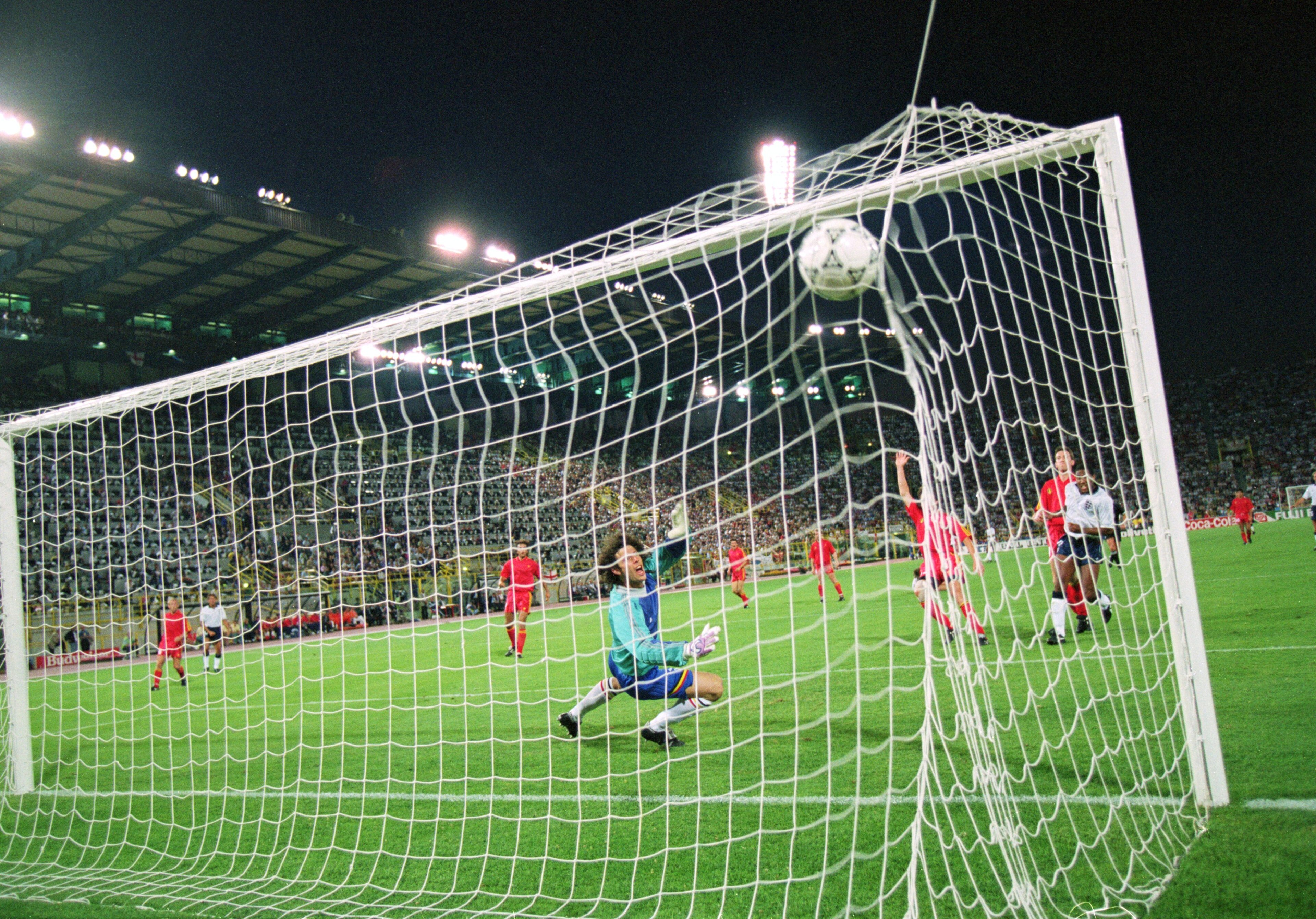 26 Jun 1990:  John Barnes of England (L) shoots past Michel Preud'homme of Belgium, but the goal is ruled out for offside during the FIFA World Cup Finals 1990 second round match against Belgium played at the Dall''Ara Stadium, in Bologna, Italy. England