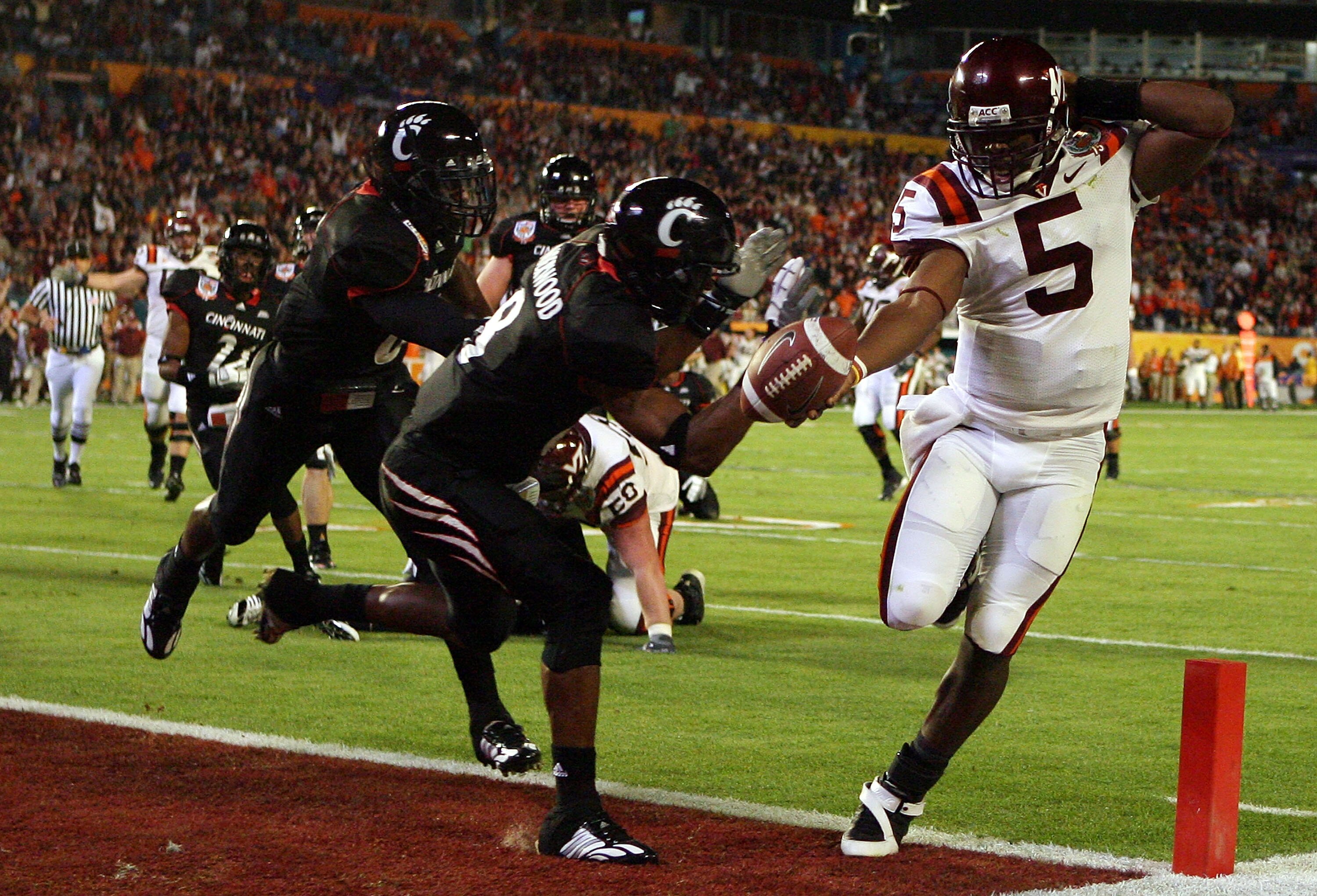 MIAMI - JANUARY 01:  Tyrod Taylor #5 of the Virginia Tech Hokies runs the ball for a toucdown against Brandon Underwood #8 of the Cincinnati Bearcats during the FedEx Orange Bowl against at Dolphin Stadium on January 1, 2009 in Miami, Florida.  (Photo by