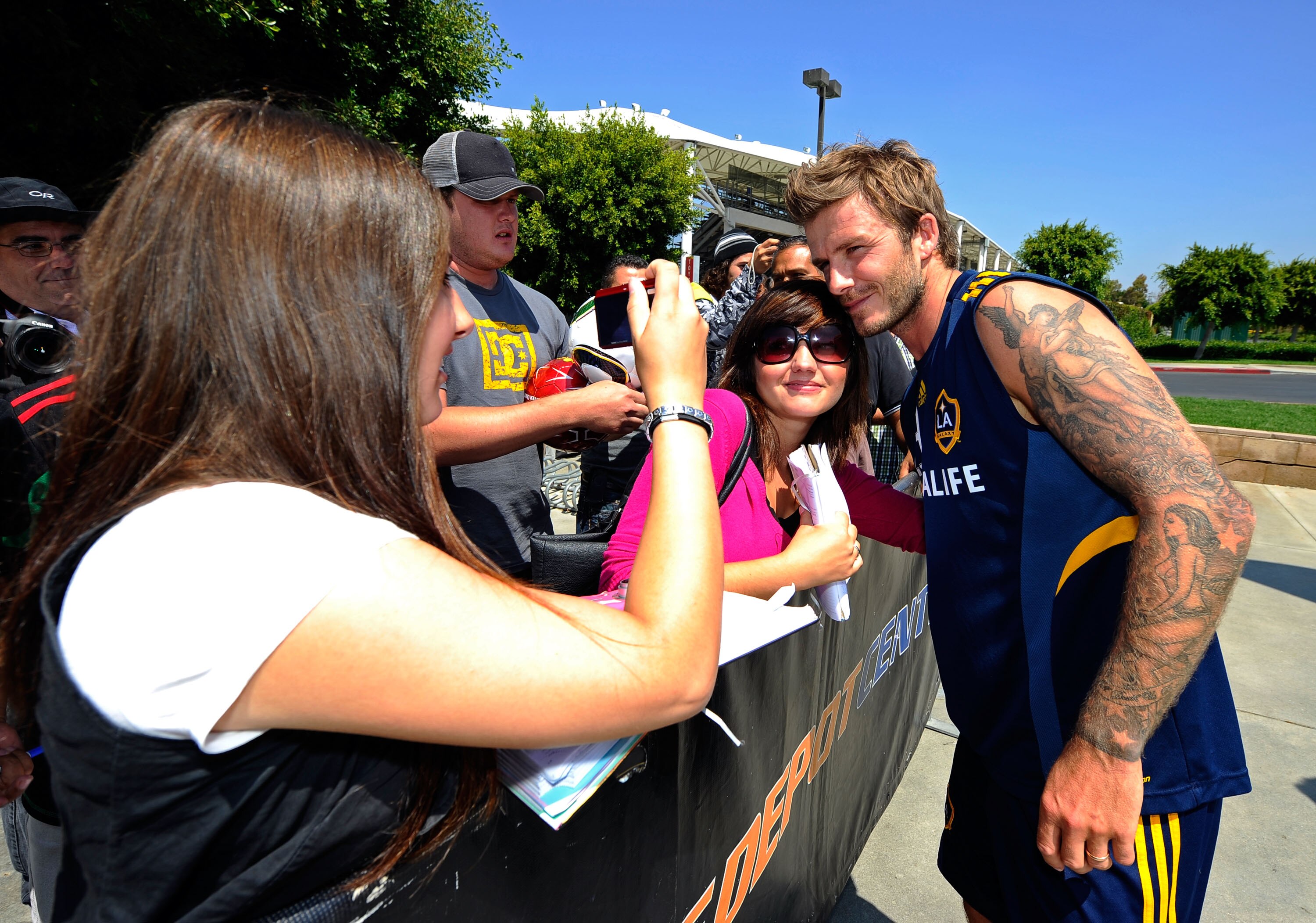 CARSON, CA - AUGUST 11:  David Beckham of the Los Angeles Galaxy gtes his picture taken with a fan after a training session at The Home Depot Center on August 11, 2010 in Carson, California. Beckham tore his left Achilles' tendon last March while on loan