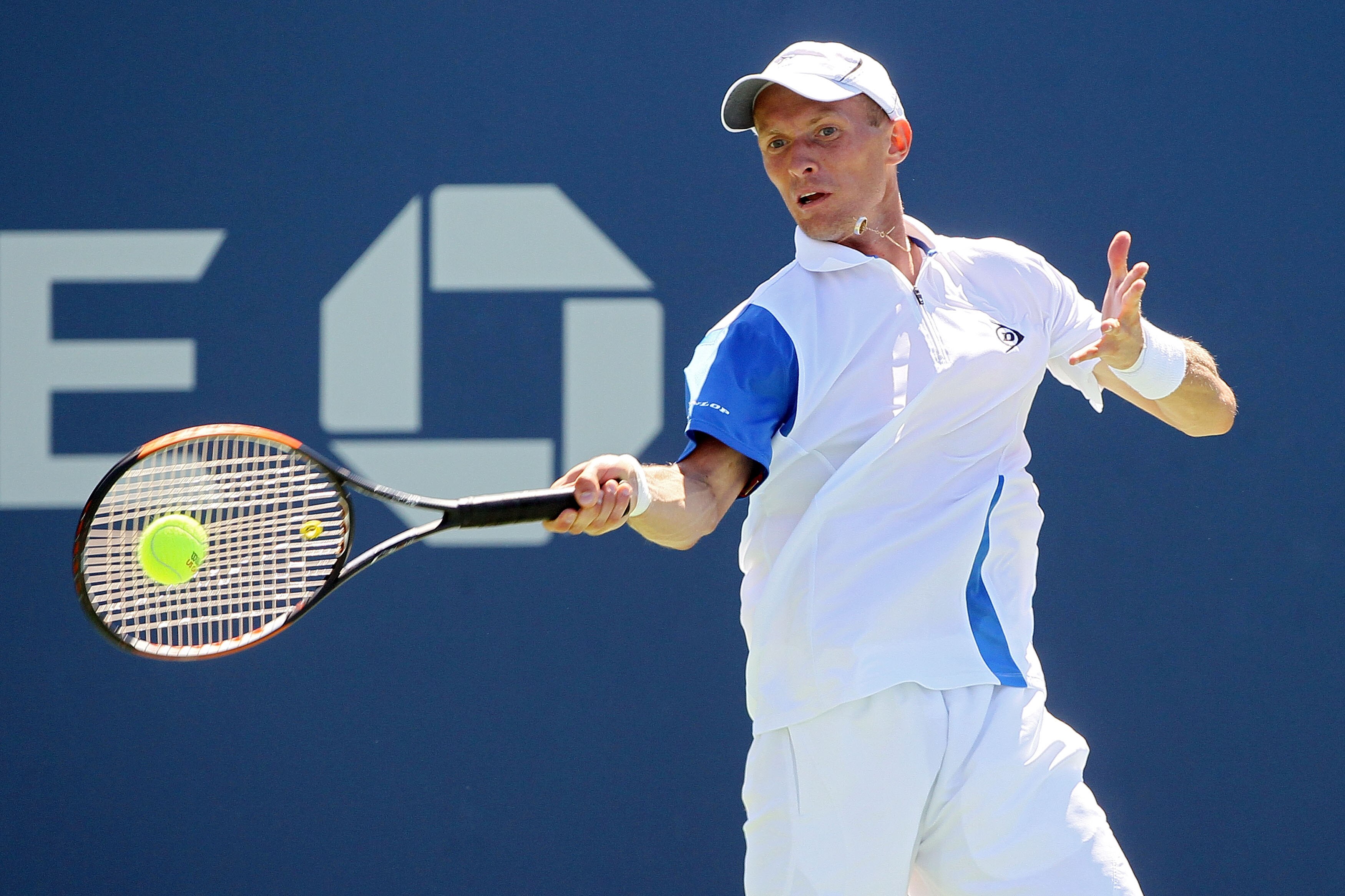 NEW YORK - AUGUST 30: Nikolay Davydenko of Russia returns a forehand against Michael Russell of the United States during the Men's Singles first round match on day one of the 2010 U.S. Open at the USTA Billie Jean King National Tennis Center on August 30 NEW YORK - AUGUST 30: Nikolay Davydenko of Russia returns a forehand against Michael Russell of the United States during the Men's Singles first round match on day one of the 2010 U.S. Open at the USTA Billie Jean King National Tennis Center on August 30