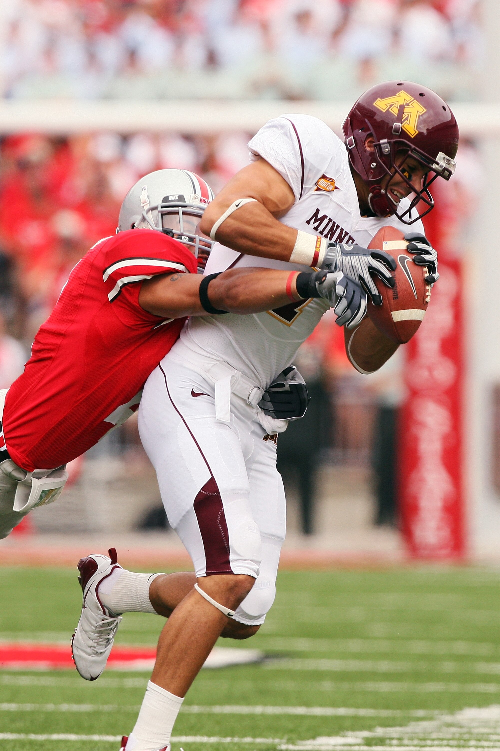 COLUMBUS, OH - SEPTEMBER 27:  Wide receiver Eric Decker #7 of the Minnesota Golden Gophers holds onto a pass reception as Kurt Coleman #4 of the Ohio State Buckeyes makes the tackle on September 27, 2008 at Ohio Stadium in Columbus, Ohio.  (Photo by Jamie