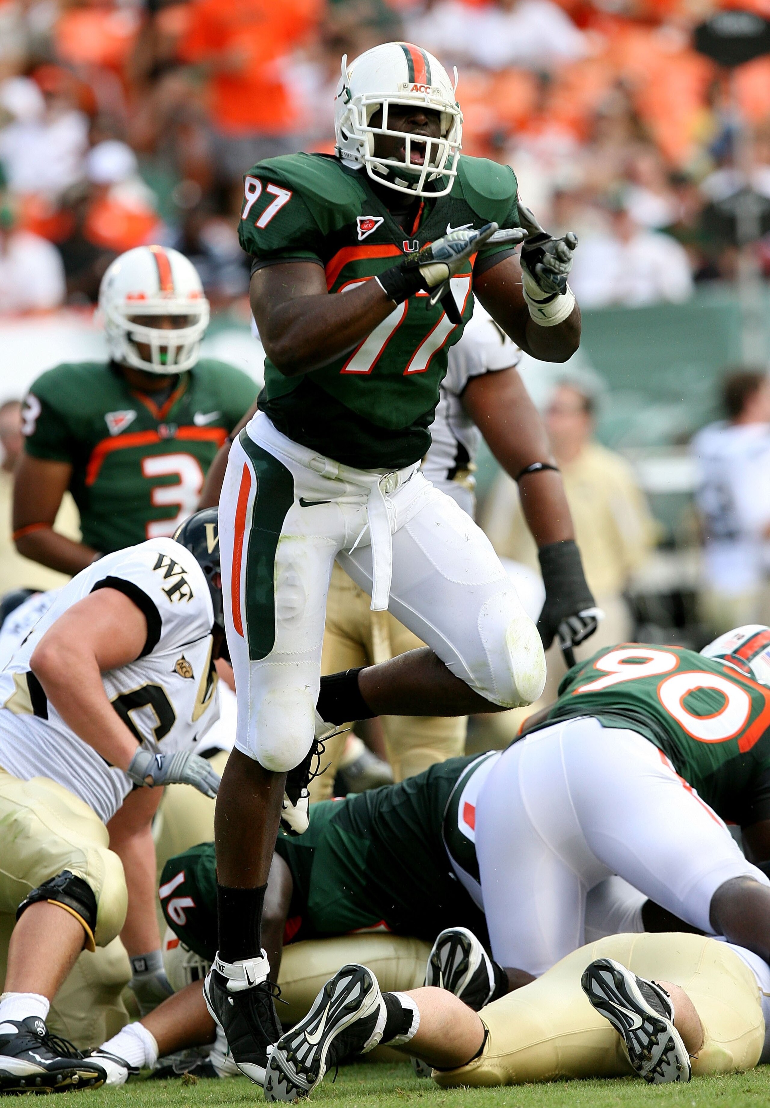MIAMI - OCTOBER 25:  Defensive lineman Adewale Ojomo #97 of the Miami Hurricanes celebrates after making a tackle for a loss of yardage against the Wake Forest Demon Decons at Dolphin Stadium on October 25, 2008 in Miami, Florida. Miami defeated Wake Fore