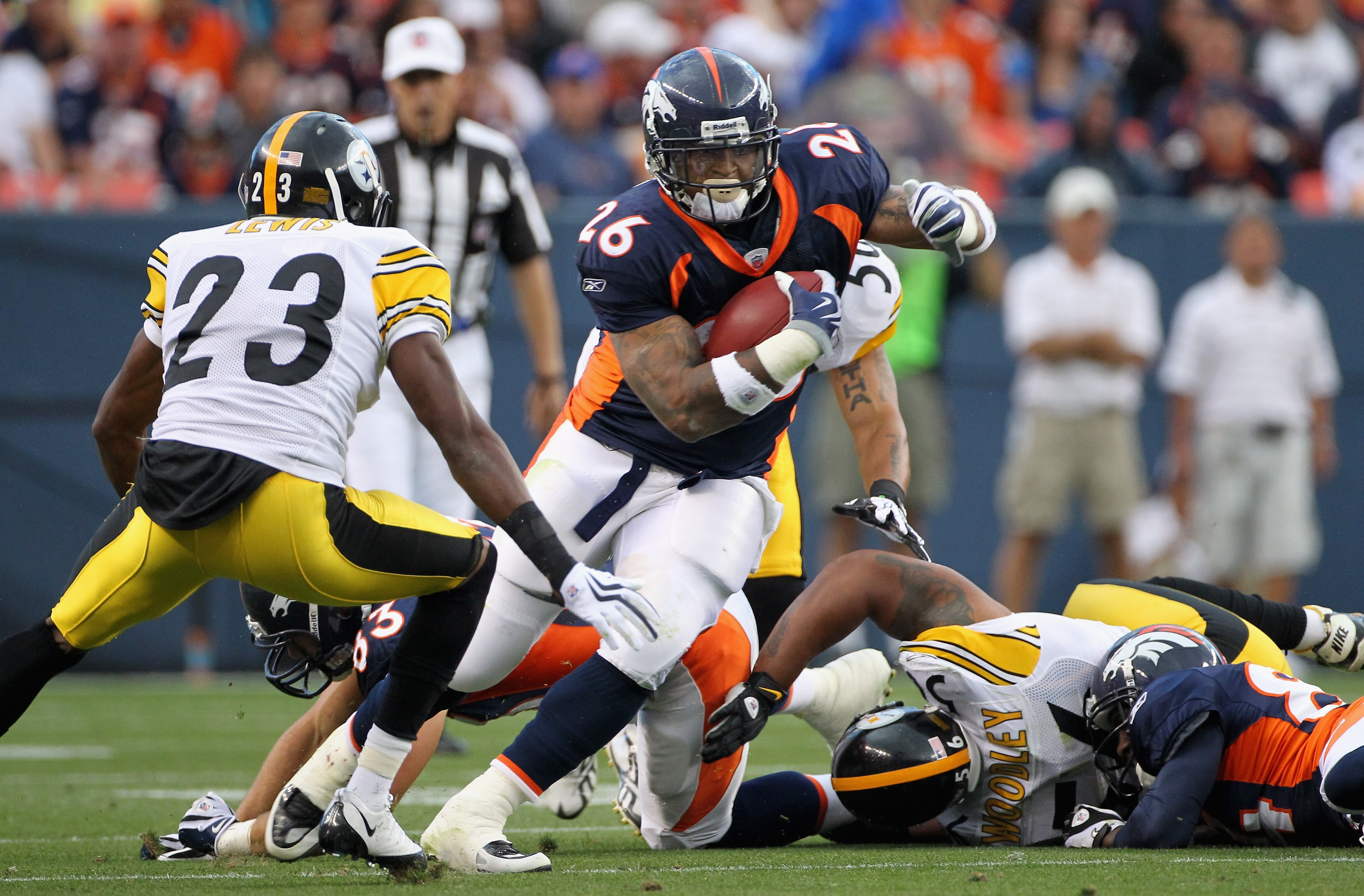 DENVER - AUGUST 29:  Running back LenDale White #26 of the Denver Broncos rushes the ball and attempts to elude cornerback Keenan Lewis #23 of the Pittsburgh Steelers during preseason NFL action at INVESCO Field at Mile High on August 29, 2010 in Denver, 