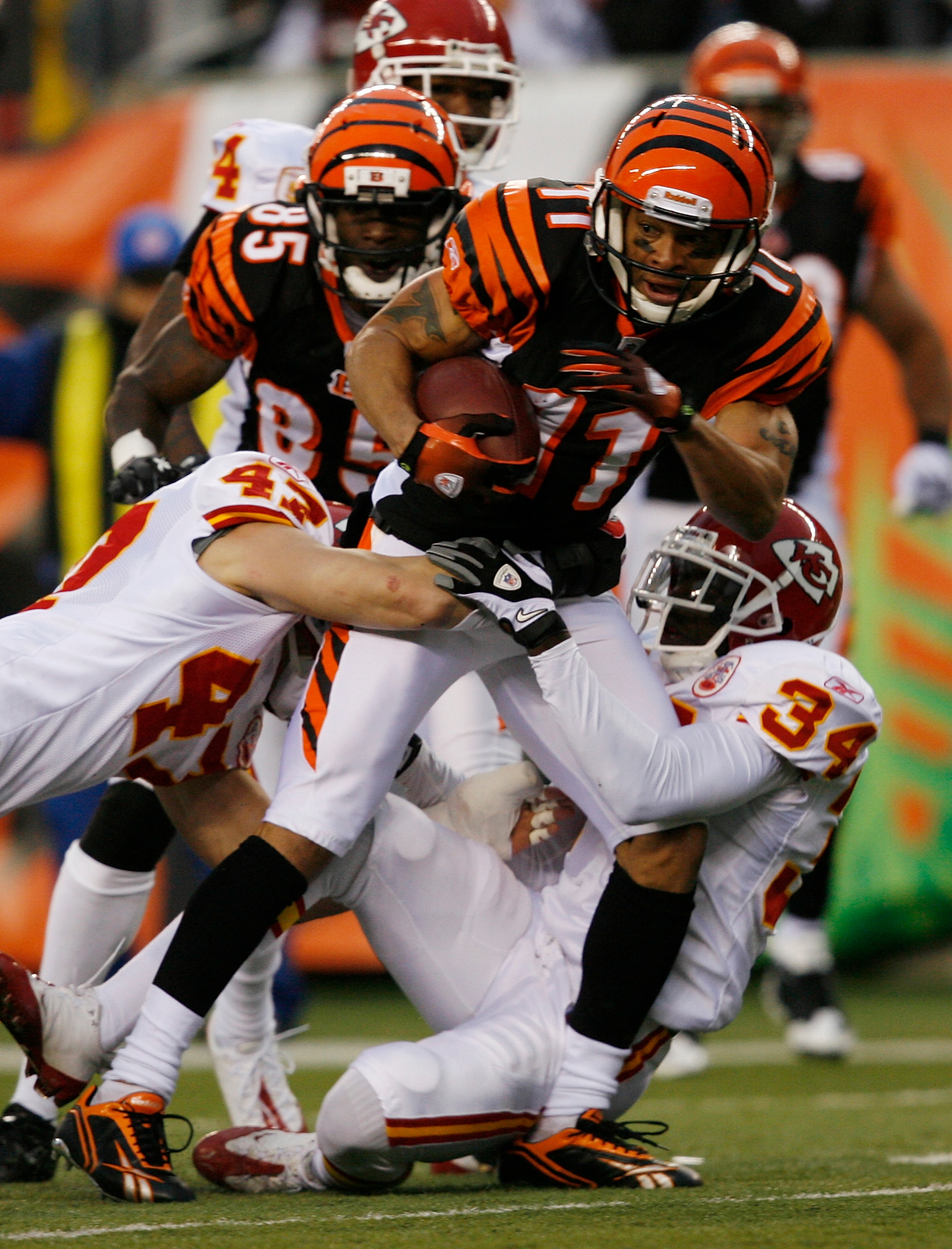 CINCINNATI - DECEMBER 27: Laveranues Coles #11 of the Cincinnati Bengals is tackled by Jon McGraw #47 and Travis Daniels #34 of the Kansas City Chiefs in their NFL game at Paul Brown Stadium December 27, 2009 in Cincinnati, Ohio.    (Photo by John Sommers