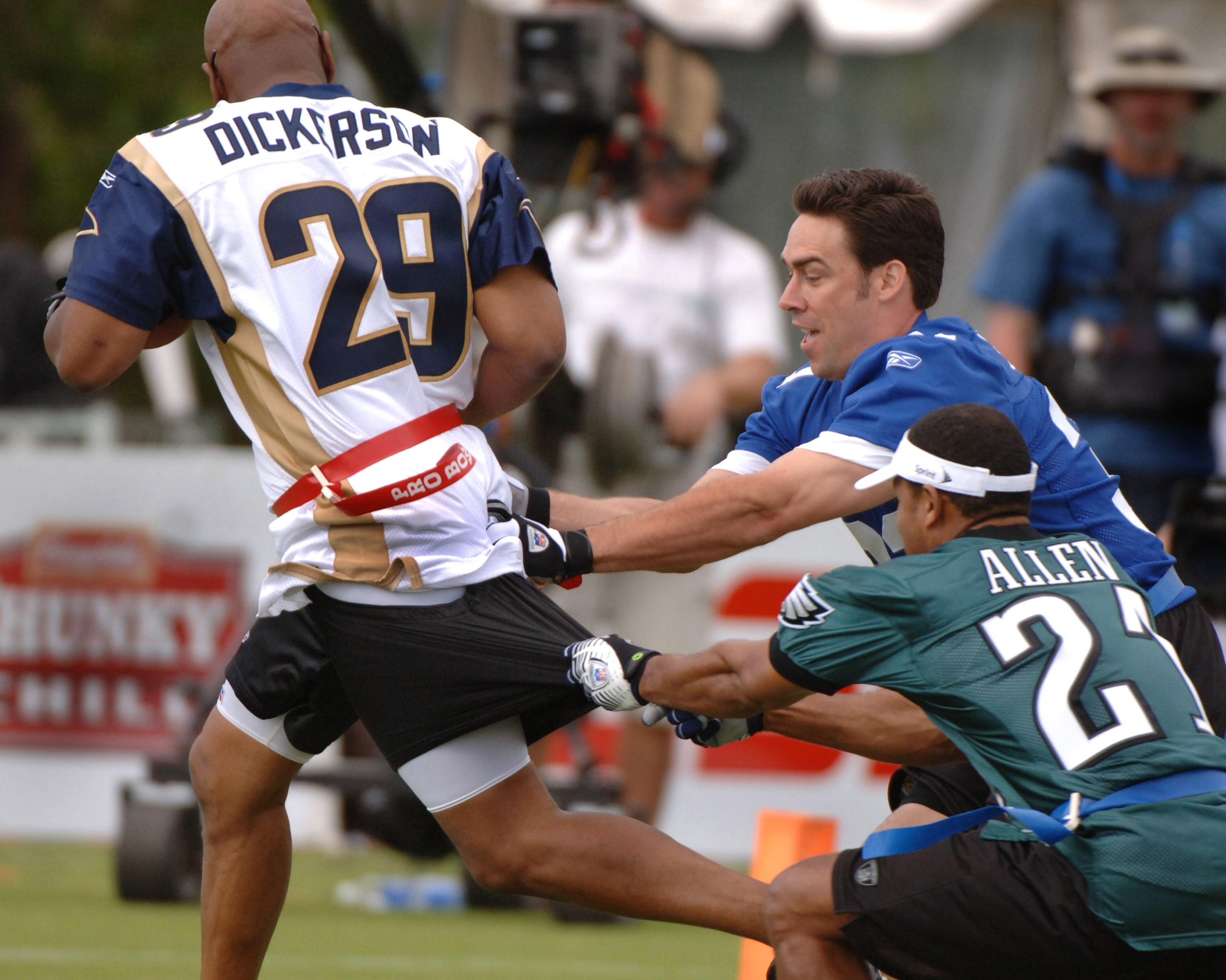 Jason Sehorn and Eric Allen tackle Eric Dickerson  during an alumni air it out flag football game February 10 before  the 2006 Pro Bowl in Honolulu.  (Photo by Al Messerschmidt/Getty Images)