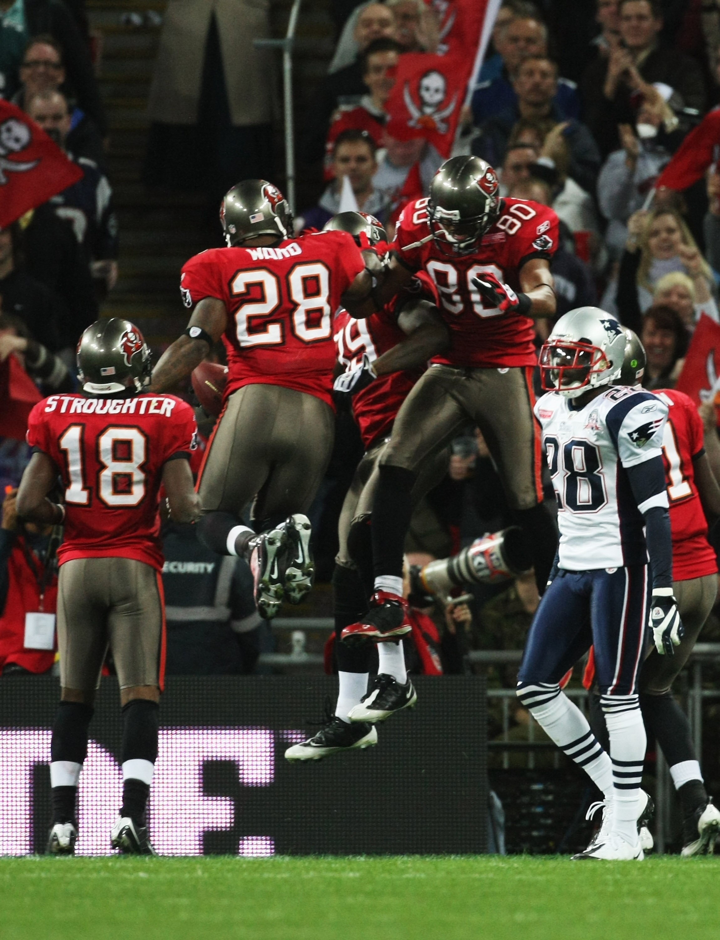 LONDON, ENGLAND - OCTOBER 25:  Antonio Bryant (#89) of Tampa Bay Buccaneers celebrates his touchdown with Michael Clayton (#80) and Derrick Ward (#28) during the NFL International Series match between New England Patriots and Tampa Bay Buccaneers at Wembl