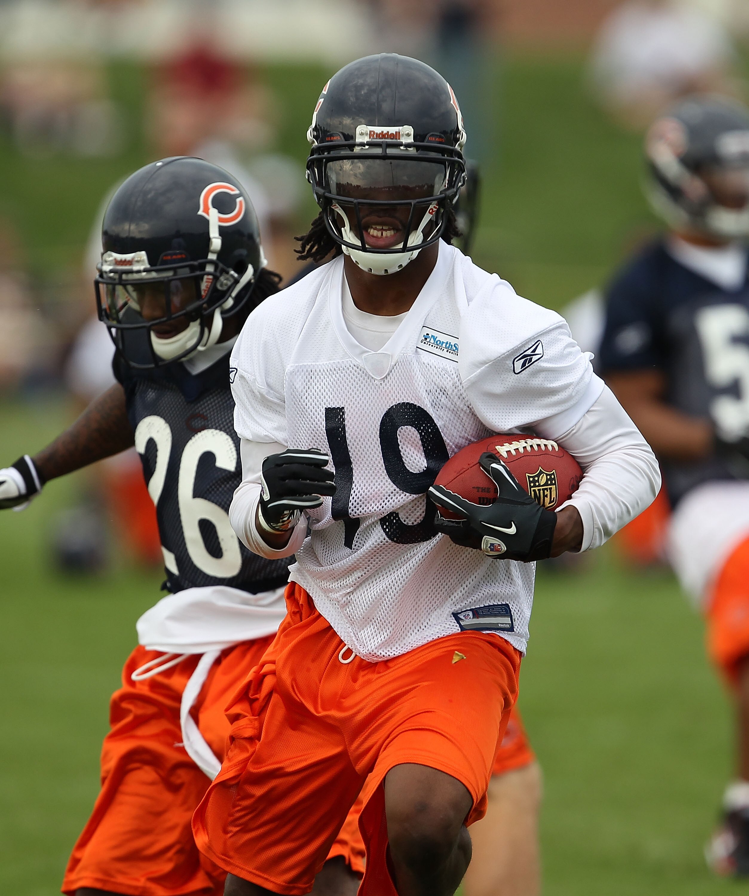 BOURBONNAIS, IL - JULY 30: Devin Aromashodu #19 of the Chicago Bears breaks away from Tim Jennings #26 after catching a pass during a summer training camp practice at Olivet Nazarene University on July 30, 2010 in Bourbonnais, Illinois. (Photo by Jonathan