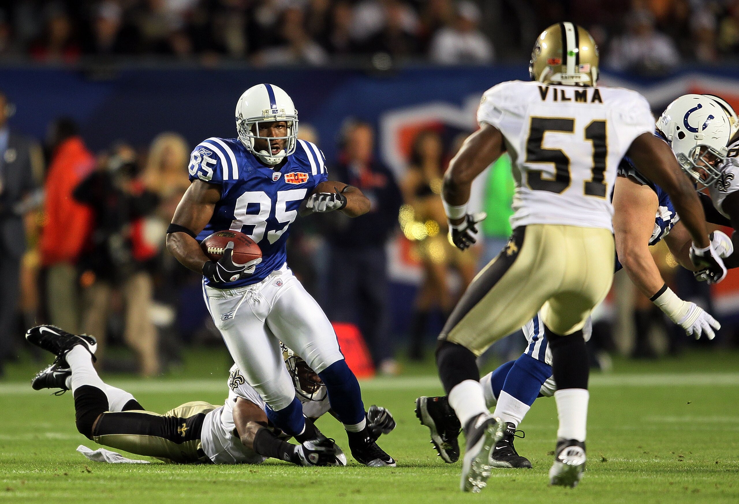 MIAMI GARDENS, FL - FEBRUARY 07: Pierre Garcon #85 of the Indianapolis Colts runs with the ball after a catch against Jonathan Vilma #51 of the New Orleans Saints during Super Bowl XLIV on February 7, 2010 at Sun Life Stadium in Miami Gardens, Florida.  (