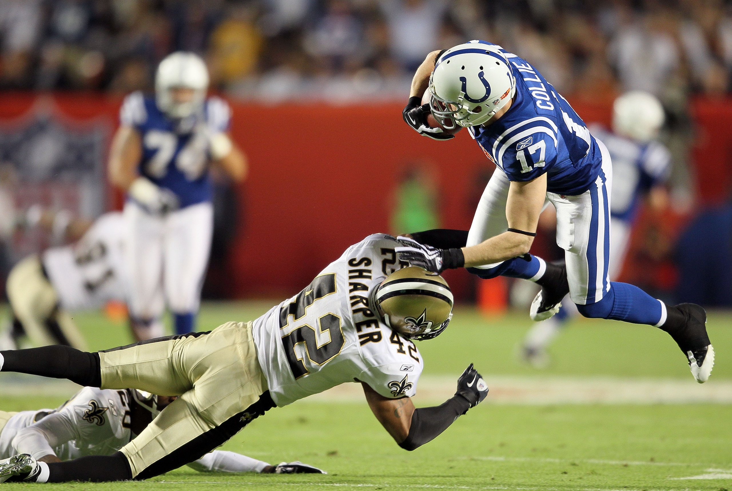 MIAMI GARDENS, FL - FEBRUARY 07:  Austin Collie #17 of the Indianapolis Colts is hit by Darren Sharper #42 of the New Orleans Saints during Super Bowl XLIV on February 7, 2010 at Sun Life Stadium in Miami Gardens, Florida.  (Photo by Andy Lyons/Getty Imag