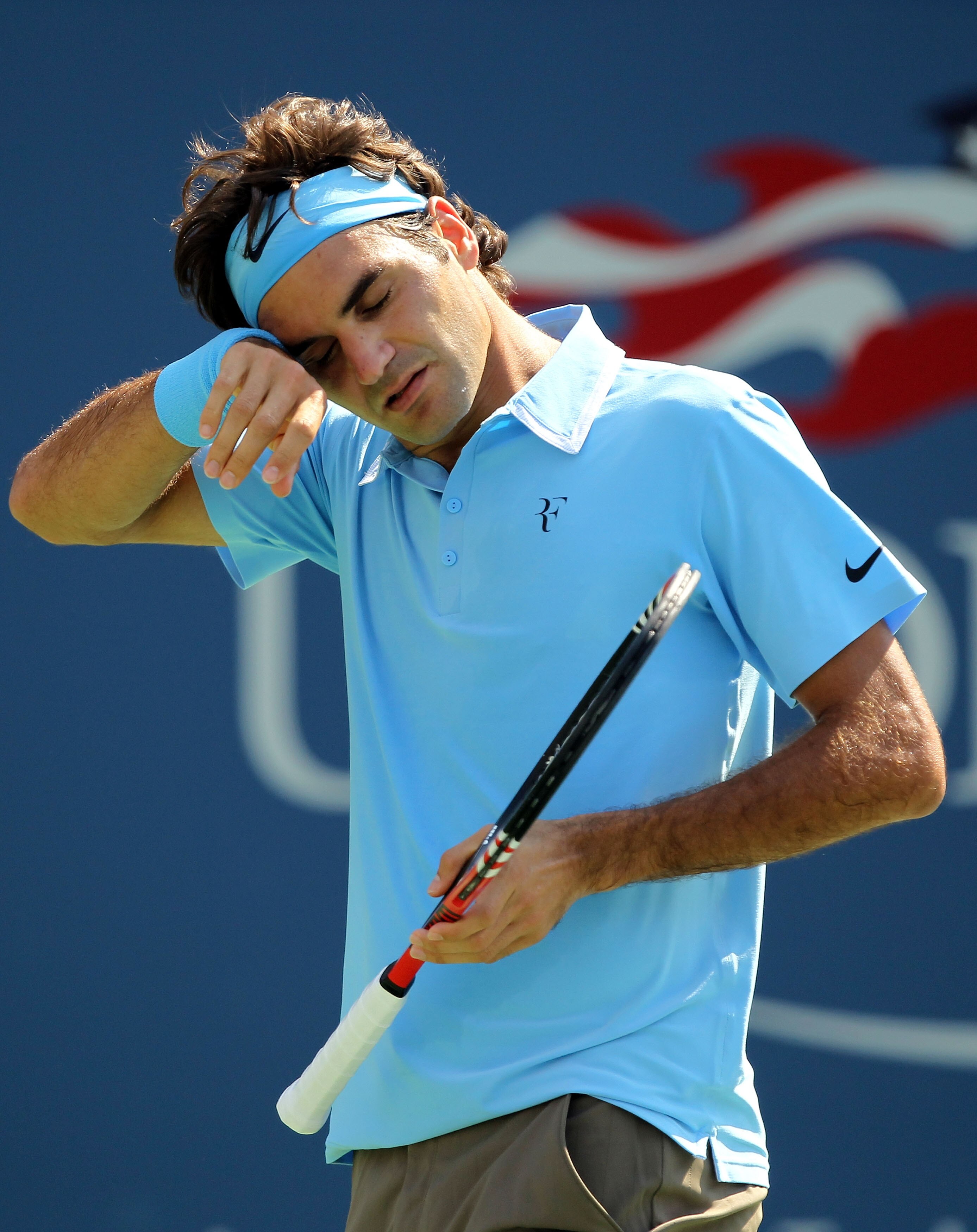 NEW YORK - SEPTEMBER 02:  Roger Federer of Switzerland wipes his head while playing against Andreas Beck of Germany during the Men's singles on day four of the 2010 U.S. Open at the USTA Billie Jean King National Tennis Center on September 2, 2010 in the