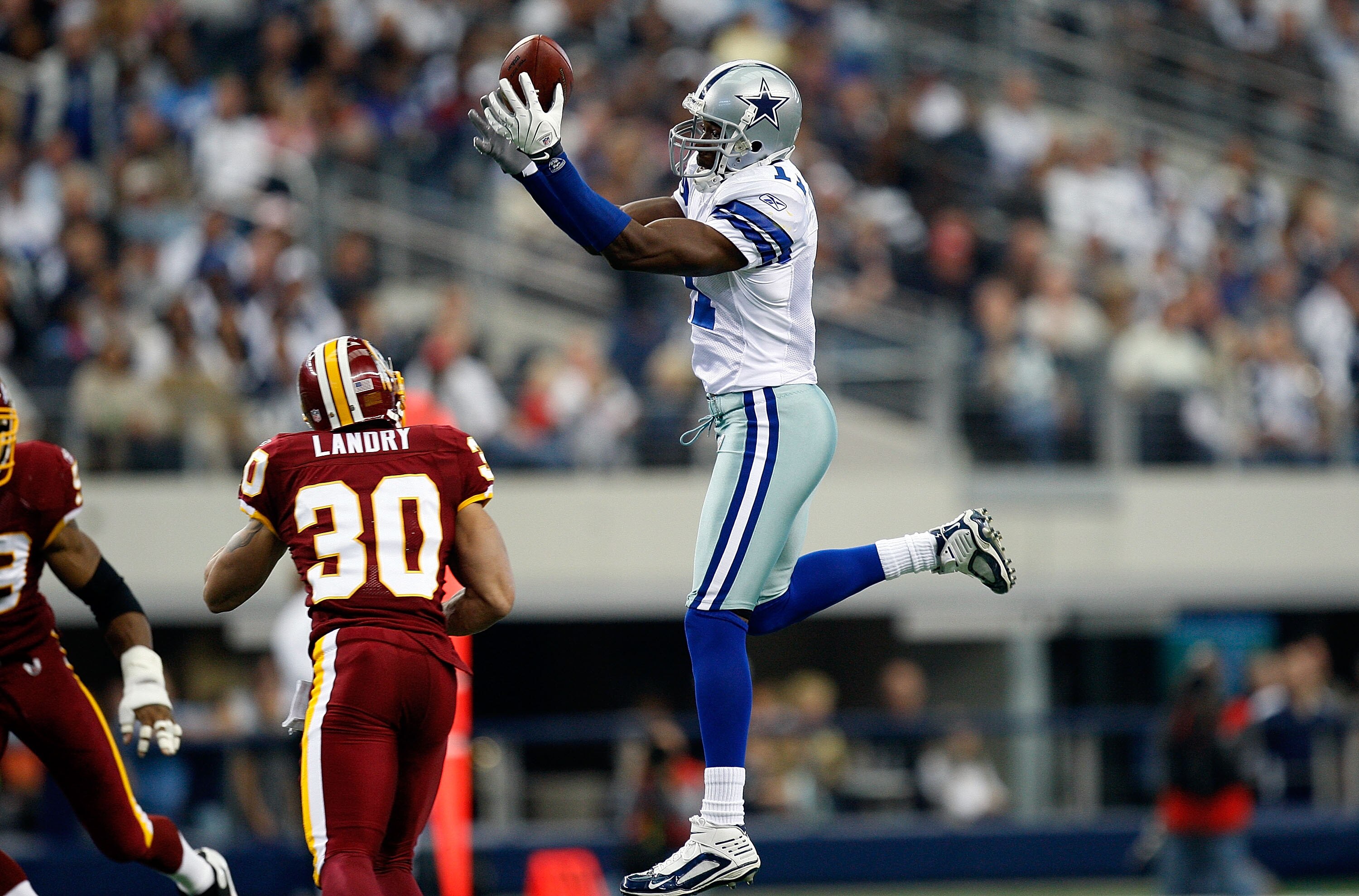 ARLINGTON, TX - NOVEMBER 22:  Wide receiver Roy Williams #11 of the Dallas Cowboys drops a pass in front of LaRon Landry #30 of the Washington Redskins at Cowboys Stadium on November 22, 2009 in Arlington, Texas.  (Photo by Ronald Martinez/Getty Images)