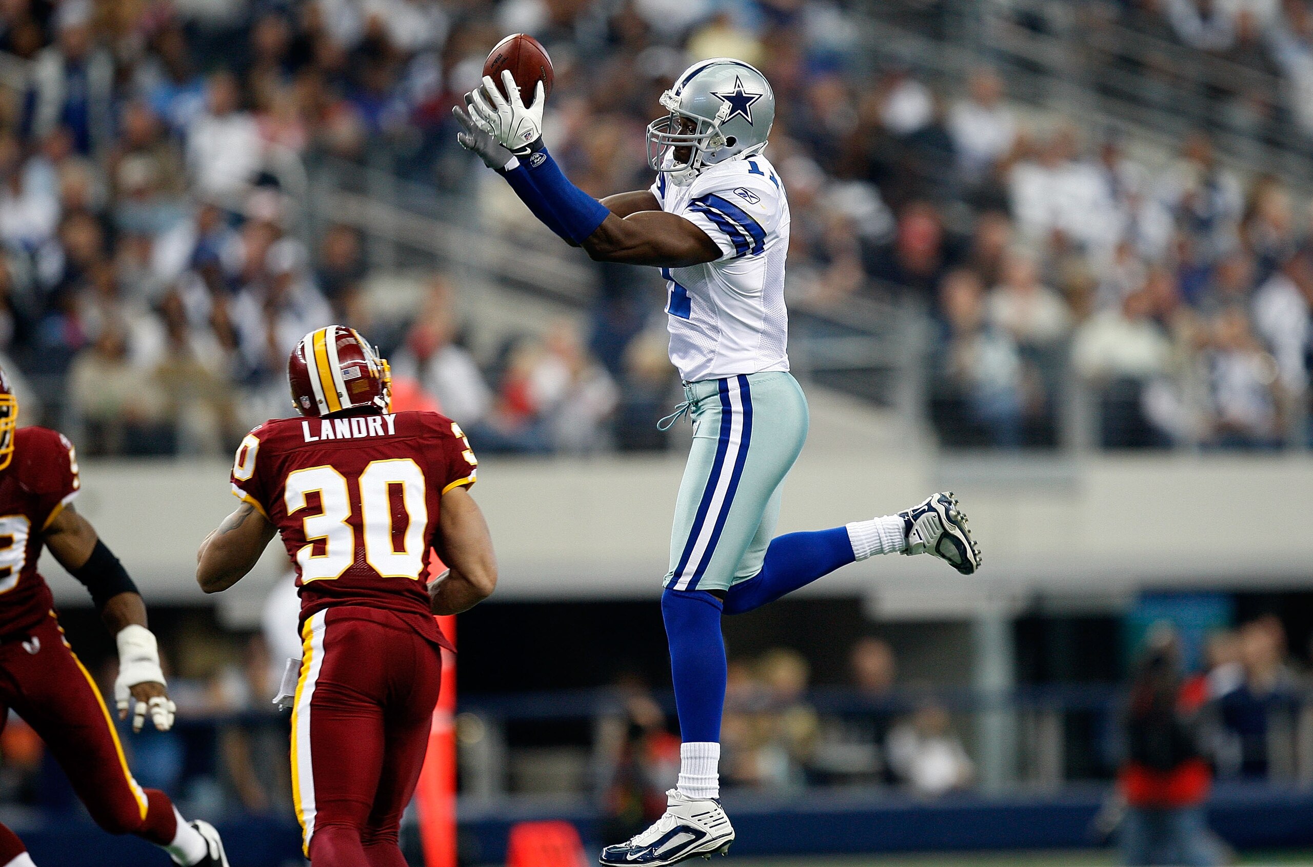 ARLINGTON, TX - NOVEMBER 22:  Wide receiver Roy Williams #11 of the Dallas Cowboys drops a pass in front of LaRon Landry #30 of the Washington Redskins at Cowboys Stadium on November 22, 2009 in Arlington, Texas.  (Photo by Ronald Martinez/Getty Images)
