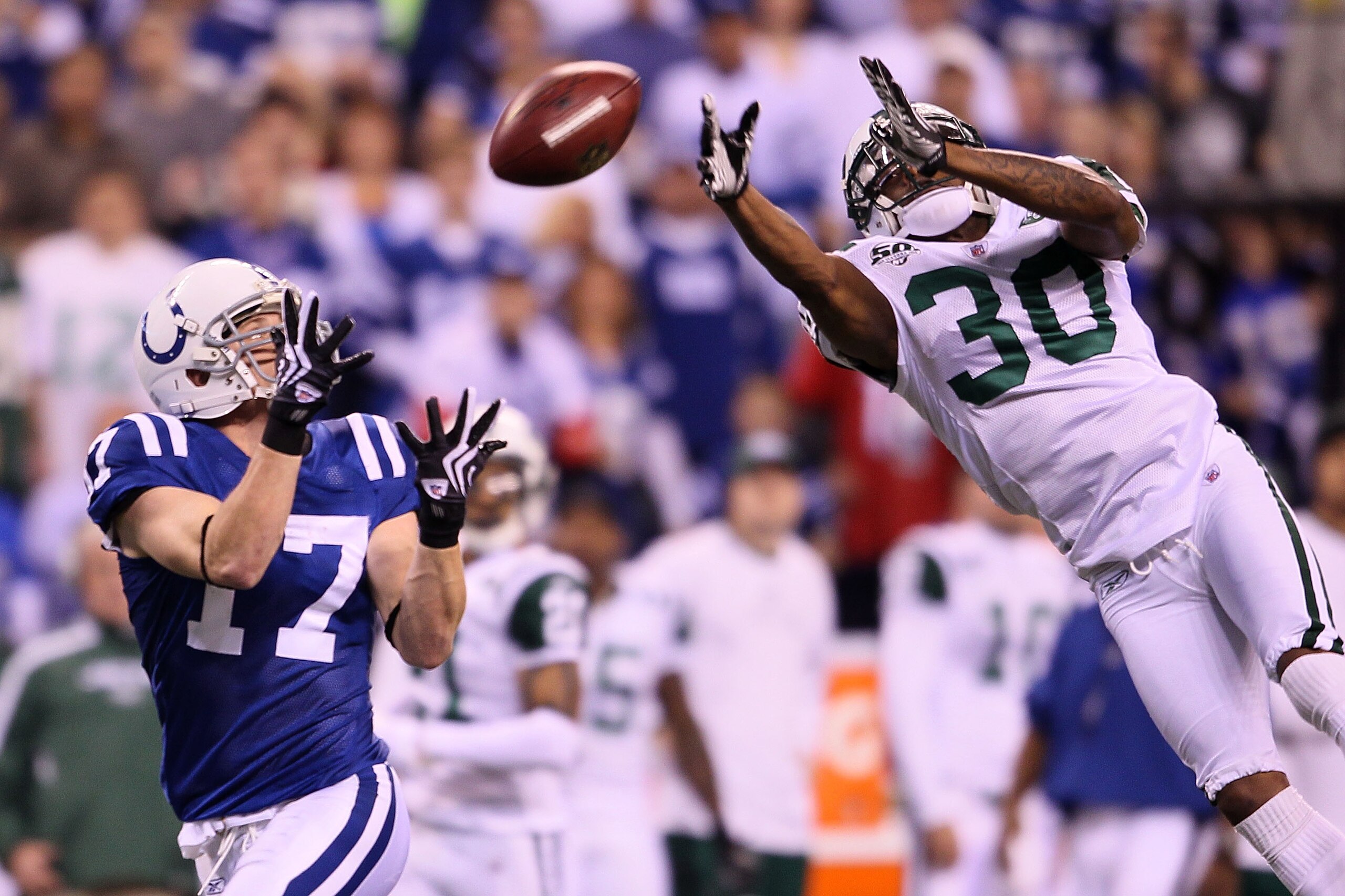 INDIANAPOLIS - JANUARY 24:  Wide receiver Austin Collie #17 of the Indianapolis Colts catches a 46-yard pass in the second quarter over Drew Coleman #30 of the New York Jets during the AFC Championship Game at Lucas Oil Stadium on January 24, 2010 in Indi