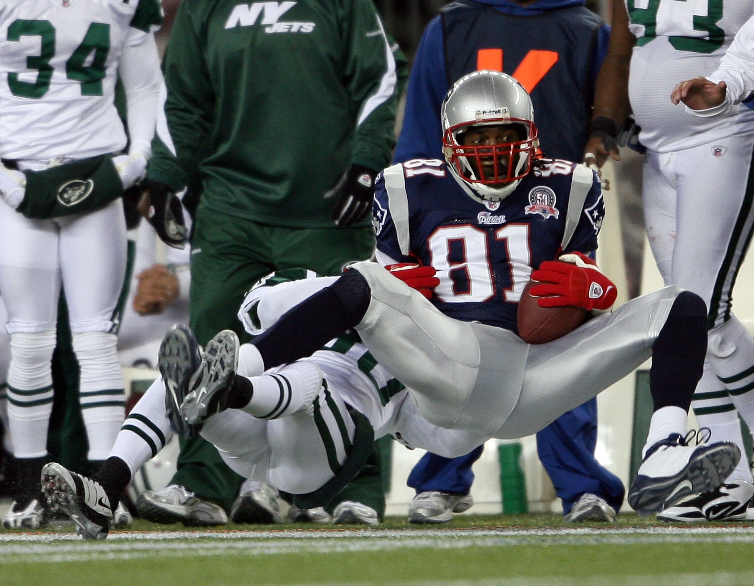 FOXBORO, MA - NOVEMBER 22:  Randy Moss #81 of the New England Patriots is tackled by Drew Coleman #30 of the New York Jets on November 22, 2009 at Gillette Stadium in Foxboro, Massachusetts.  (Photo by Elsa/Getty Images)