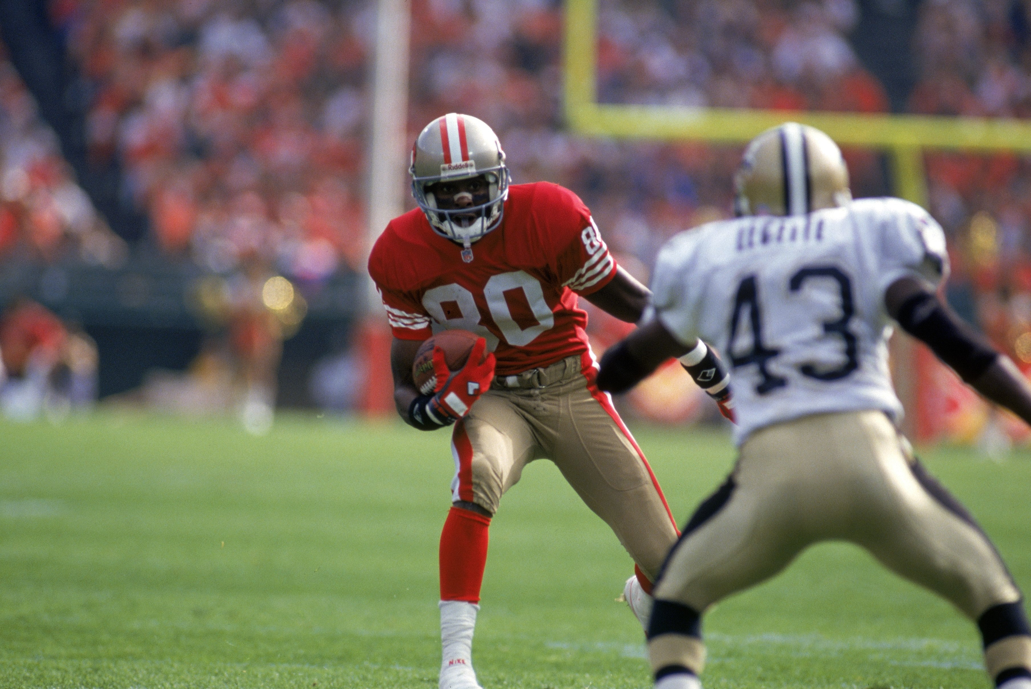 SAN FRANCISCO - OCTOBER 29:  Wide receiver Jerry Rice #80 of the San Francisco 49ers looks to make a move against New Orleans Saints cornerback Tyrone Hughes #43 during a game at Candlestick Park on October 29, 1995 in San Francisco, California.  The Sain