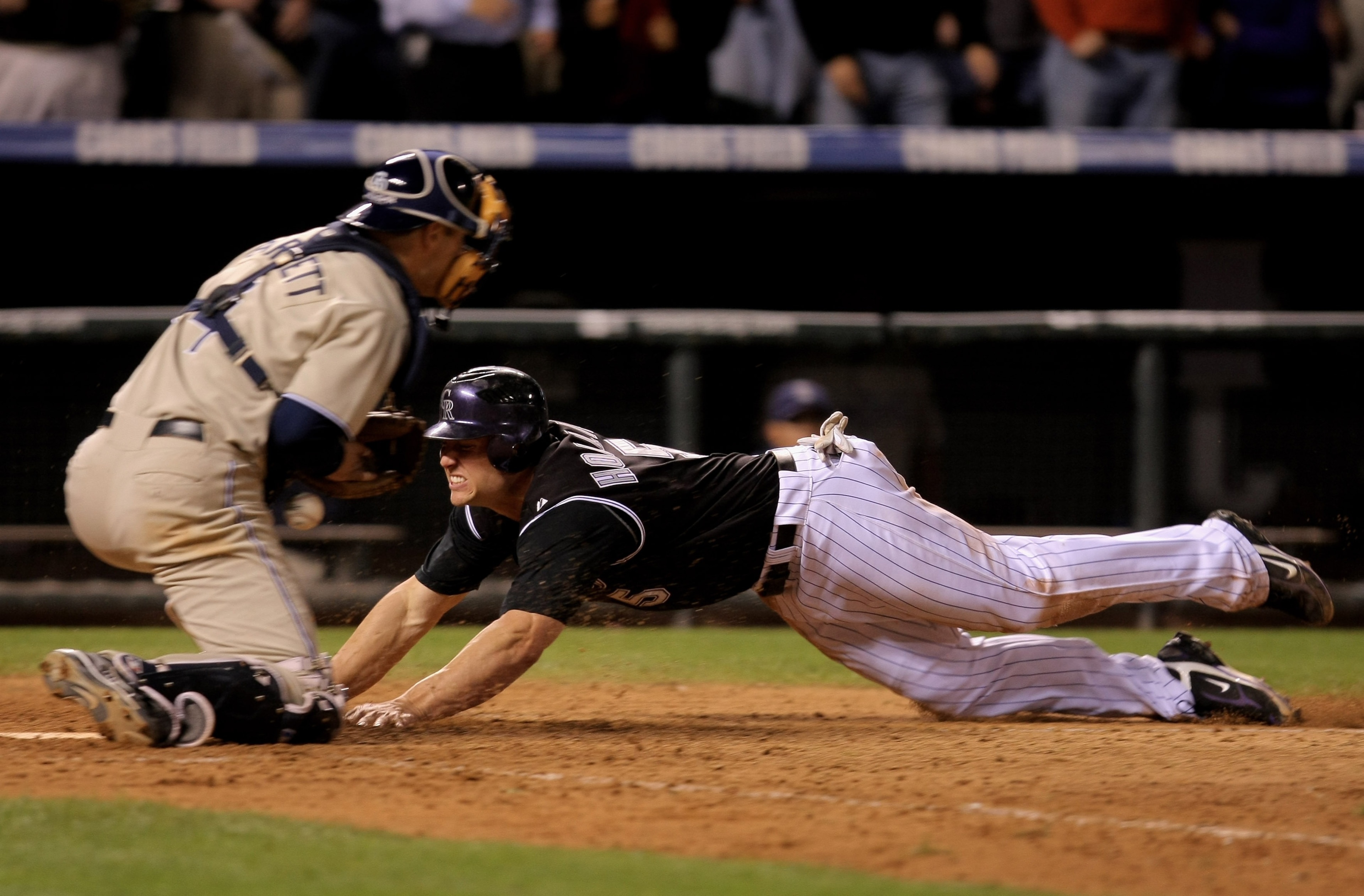 DENVER - OCTOBER 01: Matt Holliday #5 of the Colorado Rockies dives home with the winning run on a base hit by Jamey Carroll as Michael Barrett #4 of the San Diego Padres tries to control the ball at Coors Field on October 1, 2007 in Denver, Colorado. Th DENVER - OCTOBER 01: Matt Holliday #5 of the Colorado Rockies dives home with the winning run on a base hit by Jamey Carroll as Michael Barrett #4 of the San Diego Padres tries to control the ball at Coors Field on October 1, 2007 in Denver, Colorado. Th
