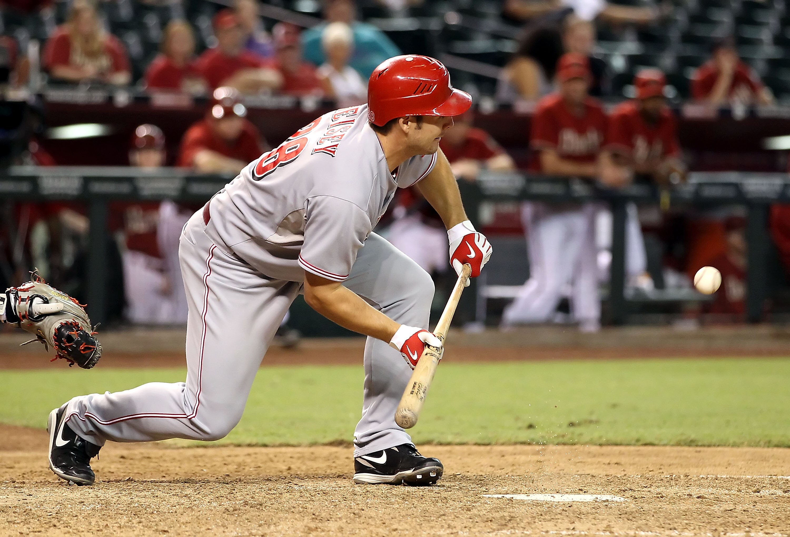 PHOENIX - AUGUST 18:  Chris Heisey #28 of the Cincinnati Reds lays down a RBI bunt single during the ninth inning of the Major League Baseball game  the Arizona Diamondbacks at Chase Field on August 18, 2010 in Phoenix, Arizona.  (Photo by Christian Peter