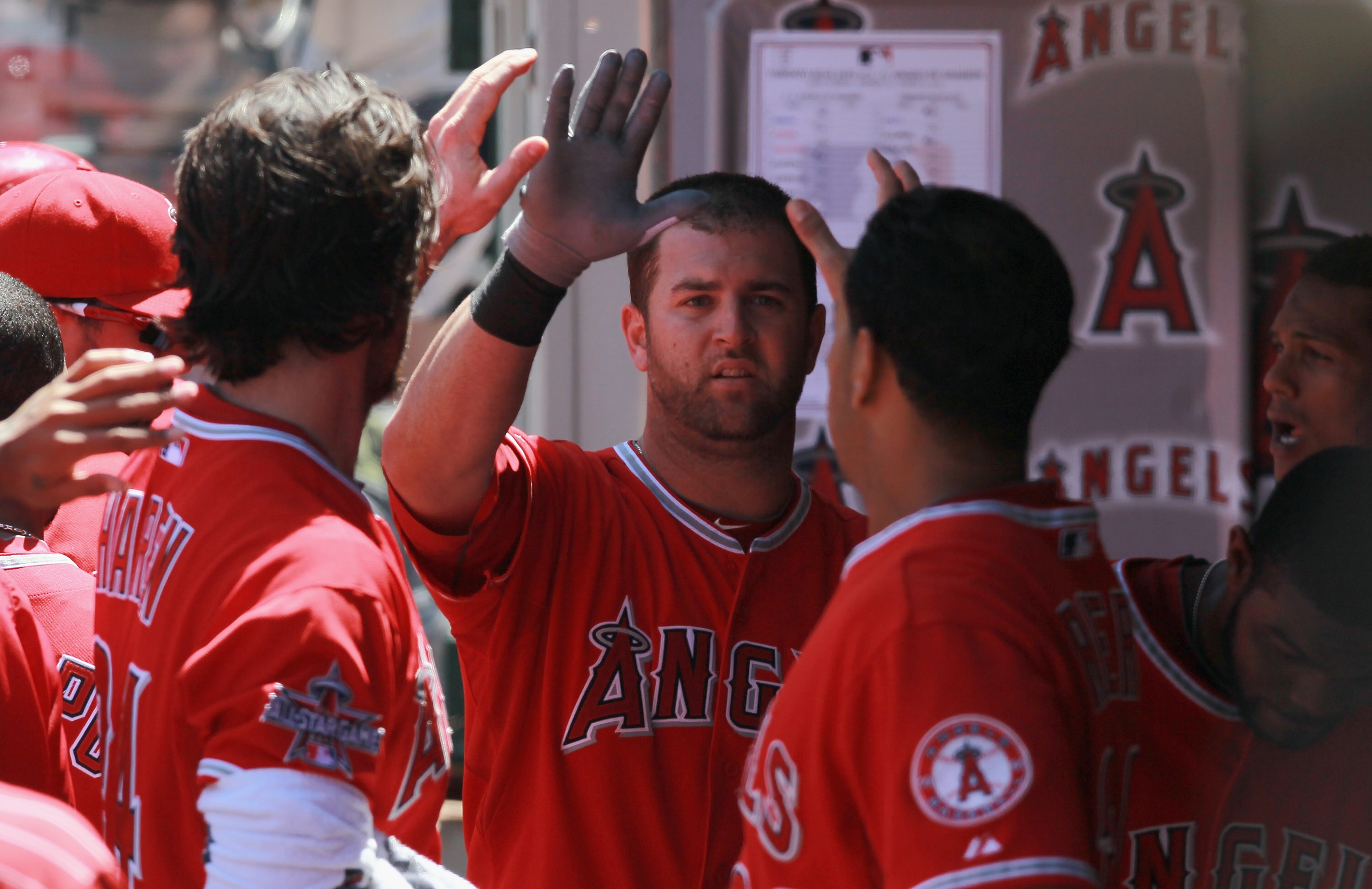 ANAHEIM, CA - AUGUST 15:  Mike Napoli #44 of the Los Angeles Angels of Anaheim receives high fives in the dugout after hitting a solo home run in the fifth inning against the Toronto Blue Jays at Angel Stadium on August 15, 2010 in Anaheim, California.  T