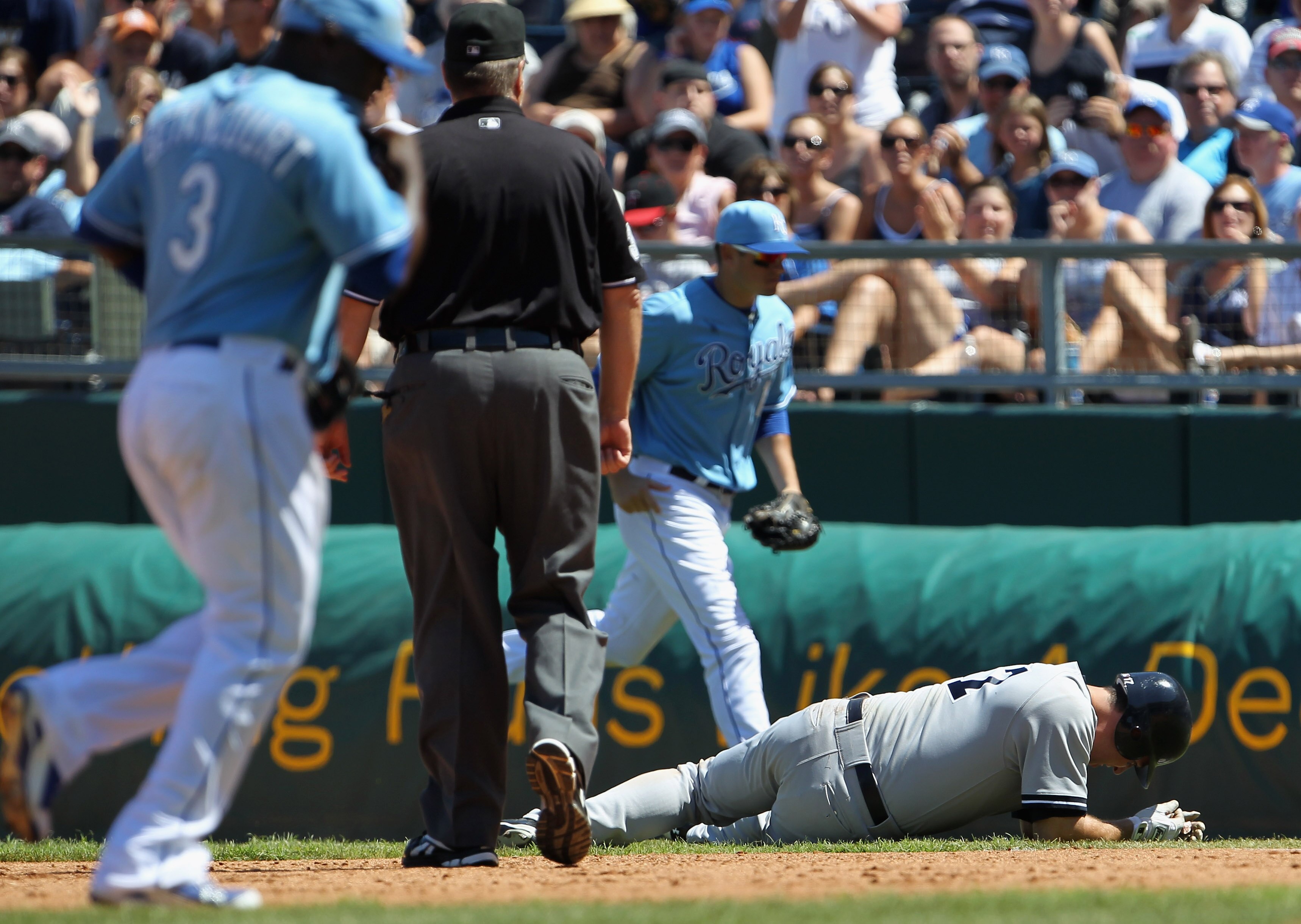 KANSAS CITY, MO - AUGUST 15:  Lance Berkman #17 of the New York Yankees falls to the ground with an injury after over-running first base during the game against the Kansas City Royals on August 15, 2010 at Kauffman stadium in Kansas City, Missouri.  (Phot