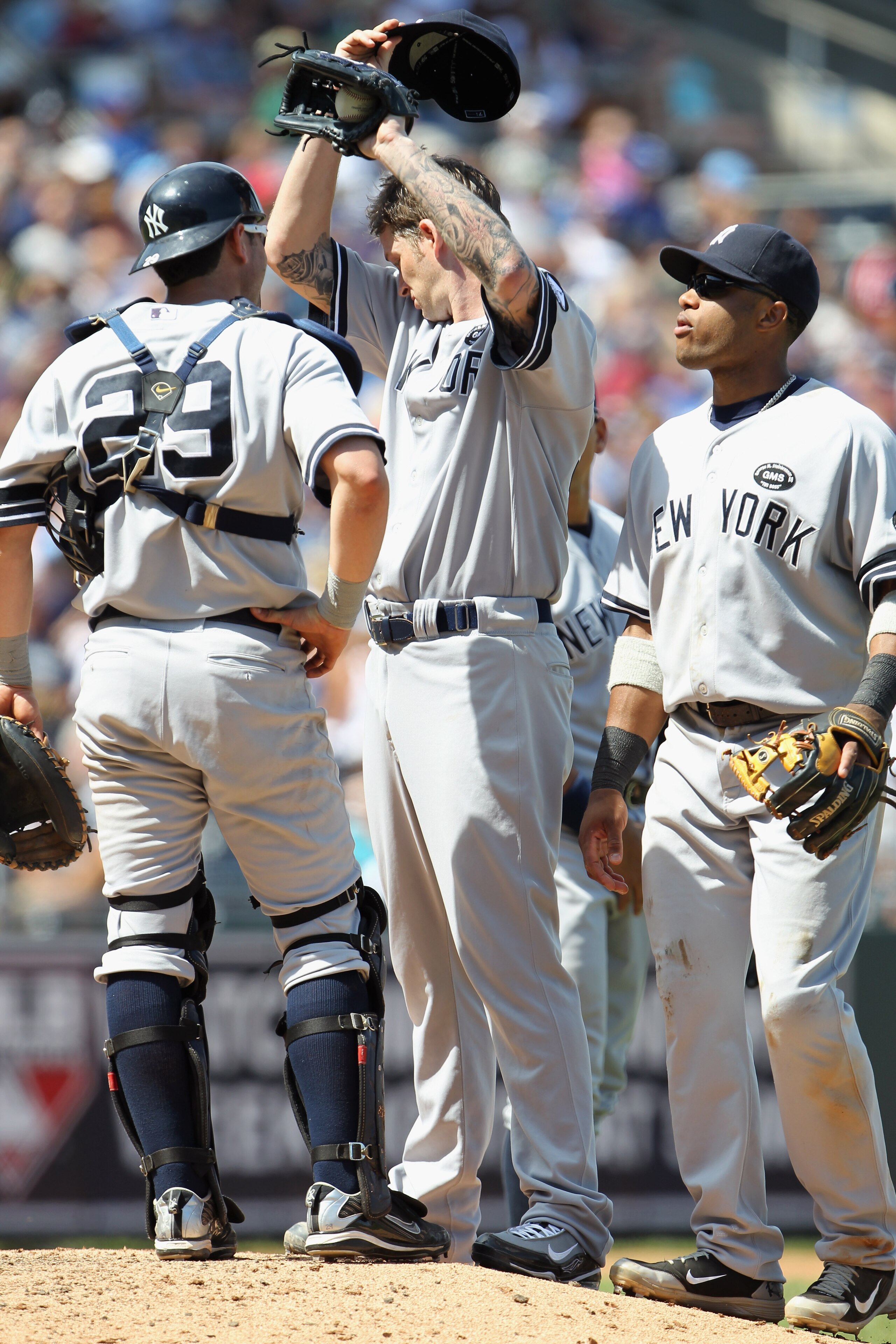 KANSAS CITY, MO - AUGUST 15:  Starting pitcher A.J. Burnett #34 of the New York Yankees wipes his brow during a mound conference in the game against the Kansas City Royals on August 15, 2010 at Kauffman stadium in Kansas City, Missouri.  (Photo by Jamie S