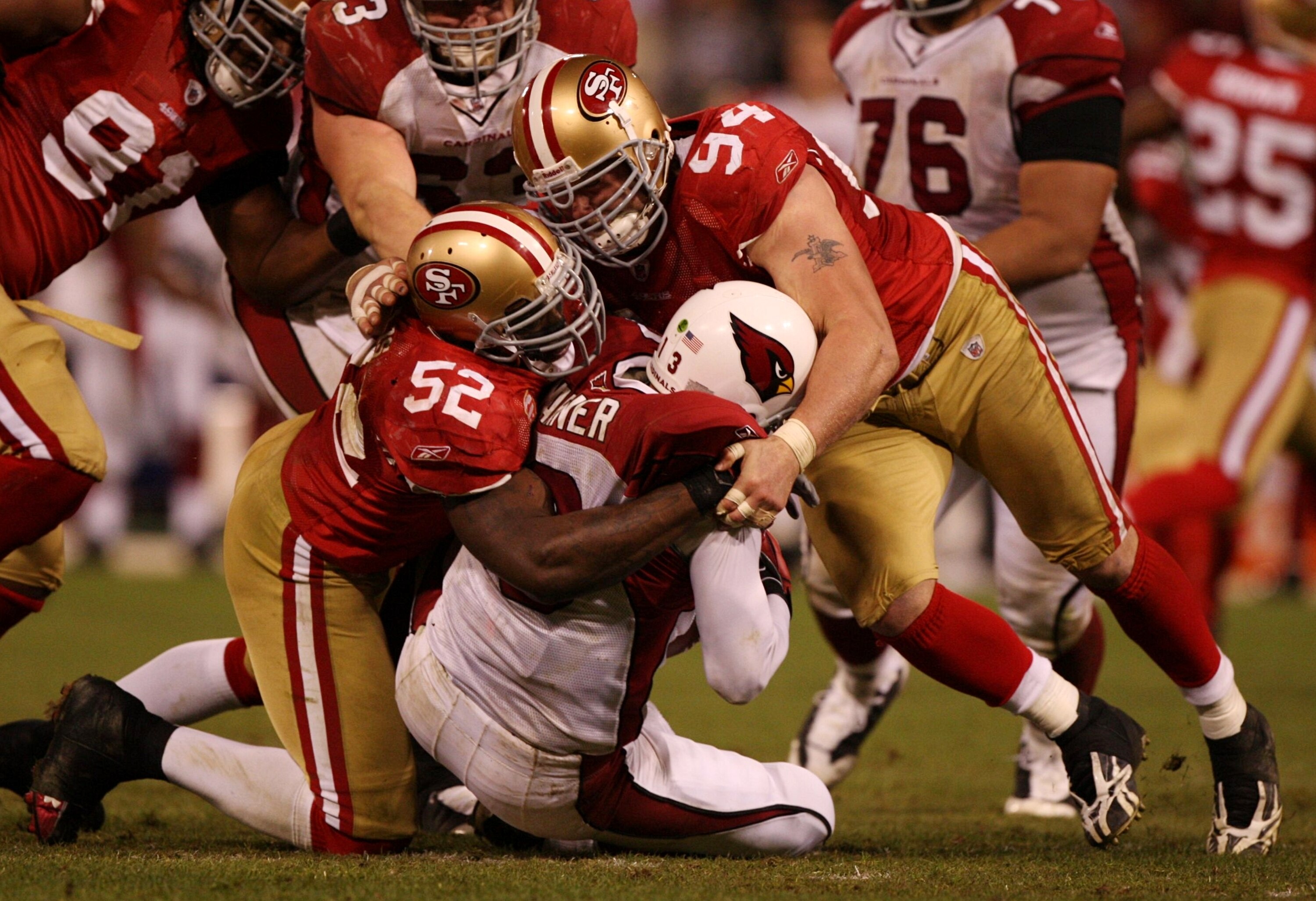 SAN FRANCISCO - DECEMBER 14:  Kurt Warner #13 of the Arizona Cardinals is sacked by Patrick Willis #52 and Justin Smith #94 of the San Francisco 49ers in the fourth quarter at Candlestick Park on December 14, 2009 in San Francisco, California. (Photo by J