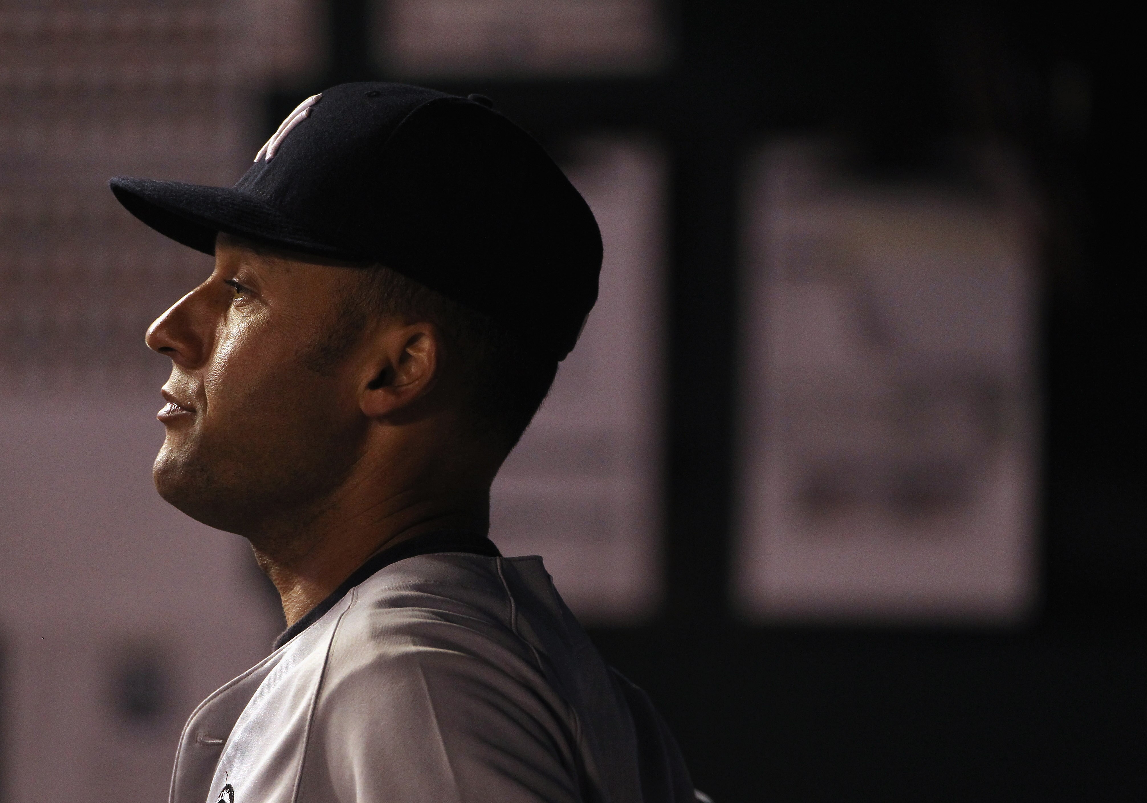 KANSAS CITY, MO - AUGUST 13:  Derek Jeter #2 of the New York Yankees watches from the dugout during a rain delay in the game against the Kansas City Royals on August 13, 2010 at Kauffman Stadium in Kansas City, Missouri.  (Photo by Jamie Squire/Getty Imag