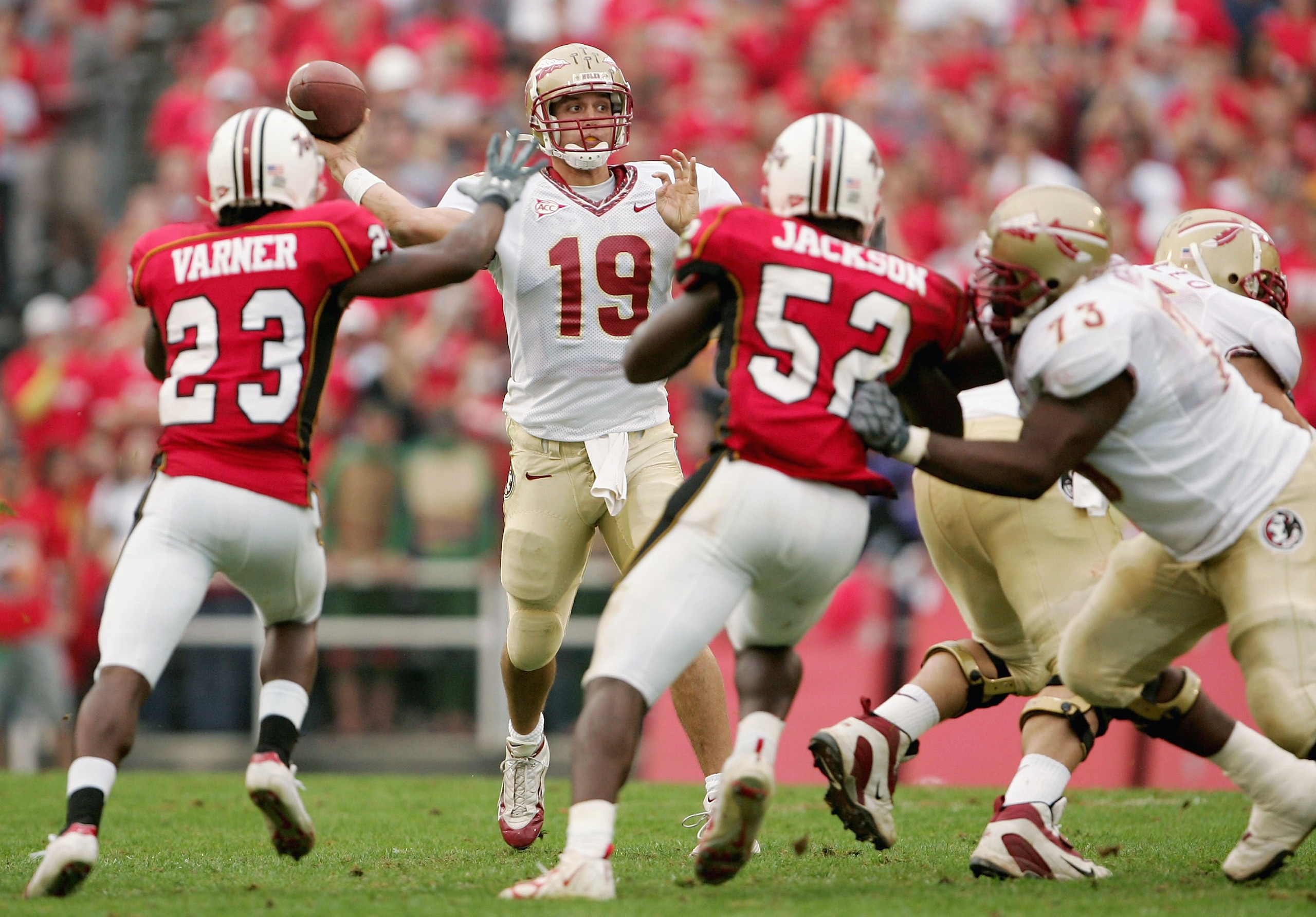COLLEGE PARK, MD - OCTOBER 30:  Quarterback Wyatt Sexton #19 of the Florida State Seminoles looks to connect with a receiver as Chris Varner #23 and D'Qwell Jackson #52 of the Maryland Terrapins provide defensive pressure as the Terps defeated the Florida