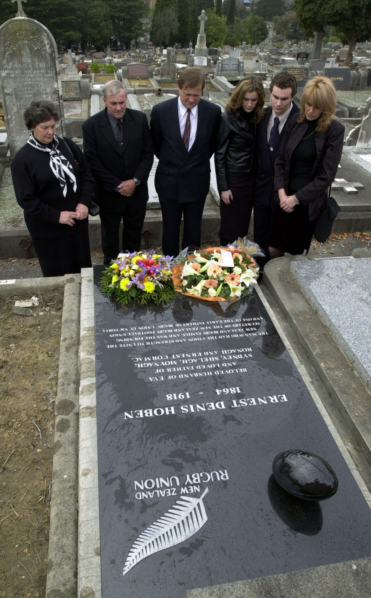 AUSTRALIA - AUGUST 30:  New Zealand Rugby Football Union President Lane Penn (2nd from left), his wife Jill (L), and Victorian Rugby Union President Bill Gillies (3rd from right) stand at the grave of NZRFU founding secretary Ernest Denis Hoben with Hoben