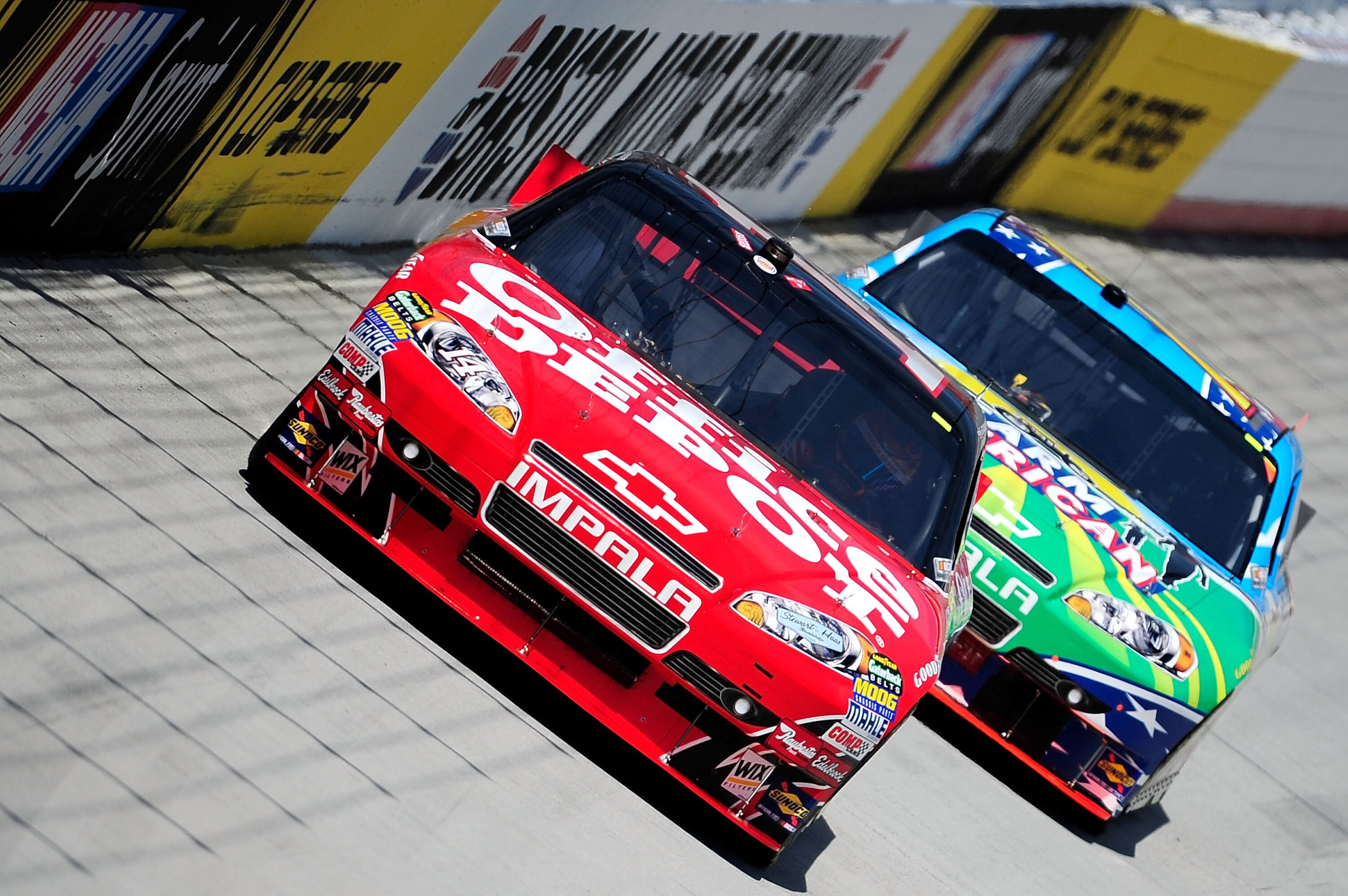 BRISTOL, TN - AUGUST 20: Tony Stewart drives the #14 Office Depot/Old Spice Chevrolet ahead of Regan Smith, driver of the #78 Farm American.com Chevrolet, during practice for the NASCAR Sprint Cup Series IRWIN Tools Night Race at Bristol Motor Speedway on