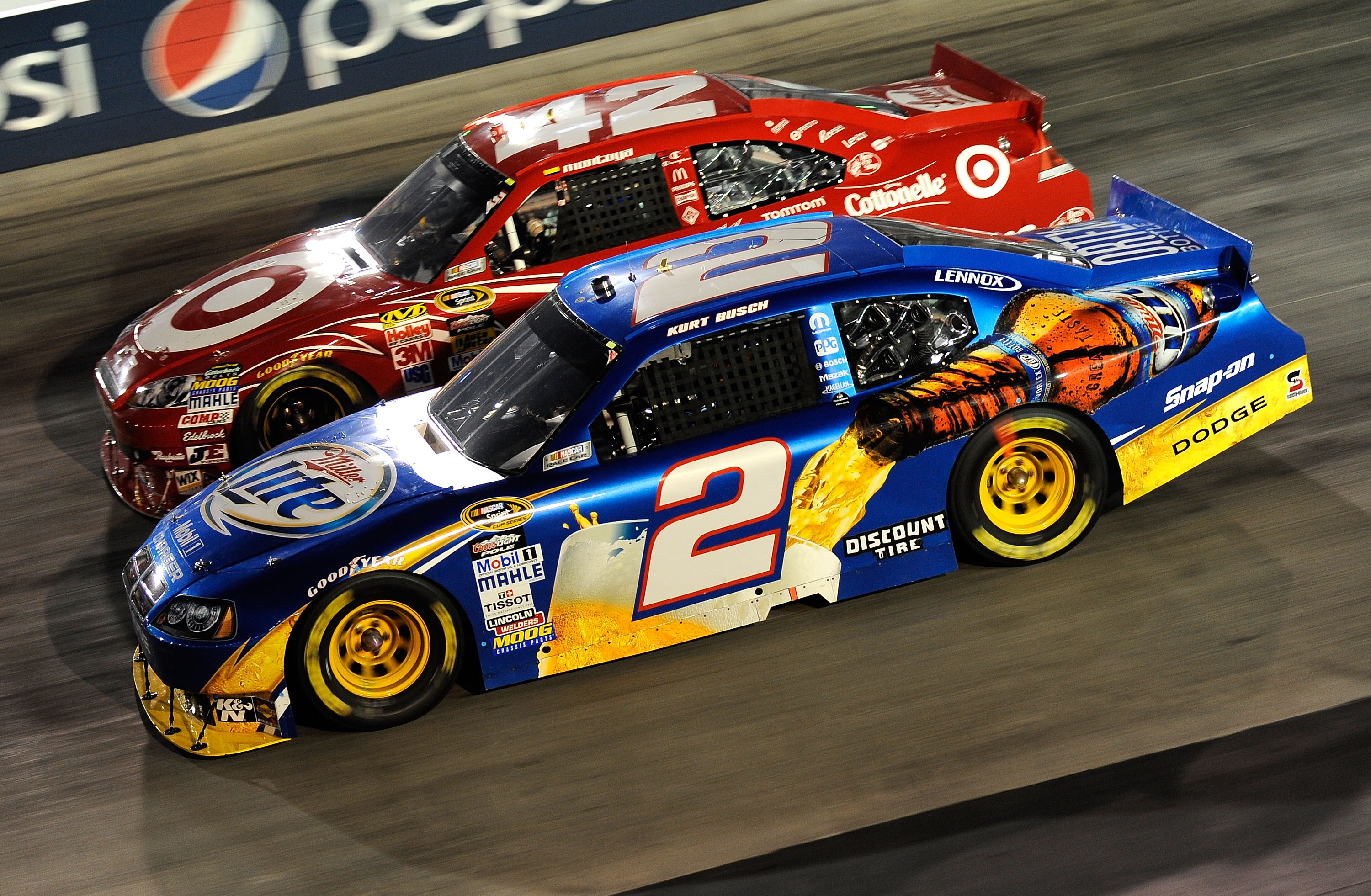 BRISTOL, TN - AUGUST 21:  Kurt Busch, driver of the #2 Miller Lite/Vortex Dodge, races Juan Pablo Montoya, driver of the #42 Target Chevrolet,during the NASCAR Sprint Cup Series IRWIN Tools Night Race at Bristol Motor Speedway on August 21, 2010 in Bristo