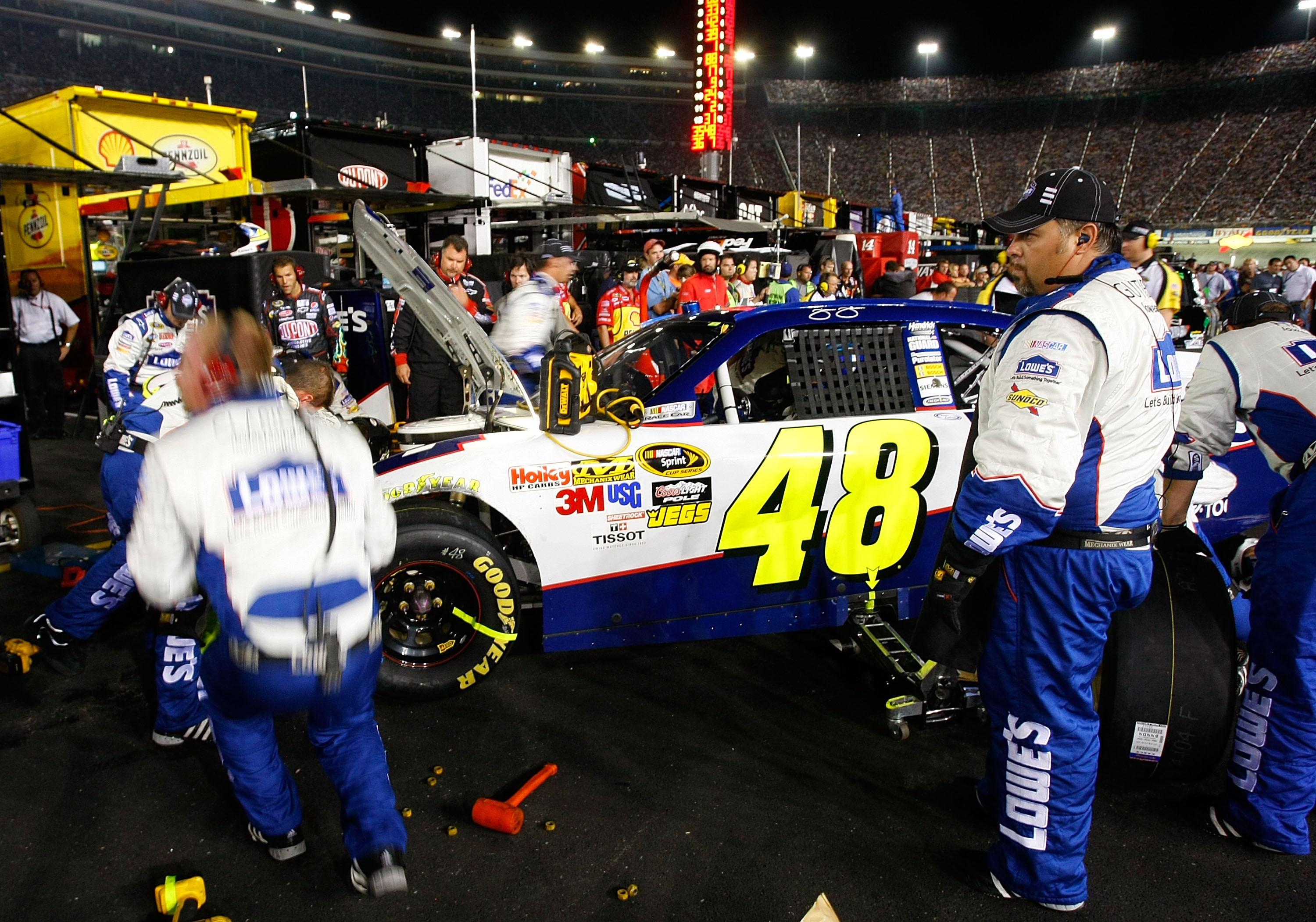BRISTOL, TN - AUGUST 21:  Crew members work on the wrecked #48 Lowe's Chevrolet, driven by Jimmie Johnson, after an incident on track in the NASCAR Sprint Cup Series IRWIN Tools Night Race at Bristol Motor Speedway on August 21, 2010 in Bristol, Tennessee